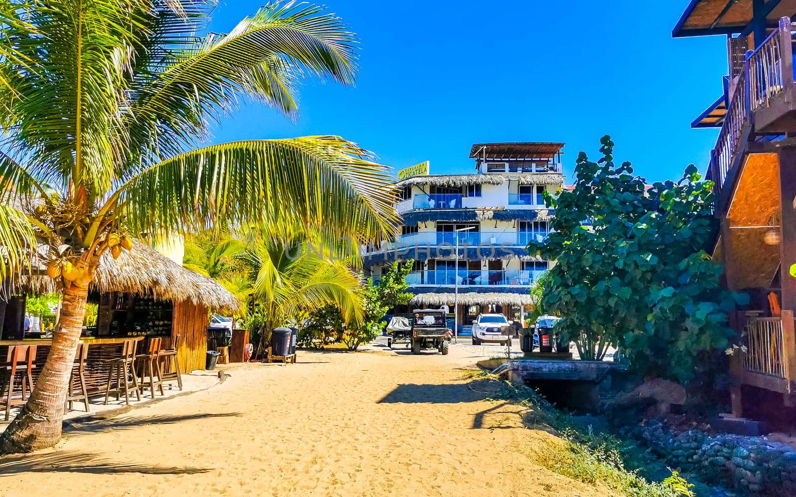 Restaurant restaurants bar bars shops hotels palms palm trees and promenades on the beach in Zicatela Puerto Escondido Oaxaca Mexico.