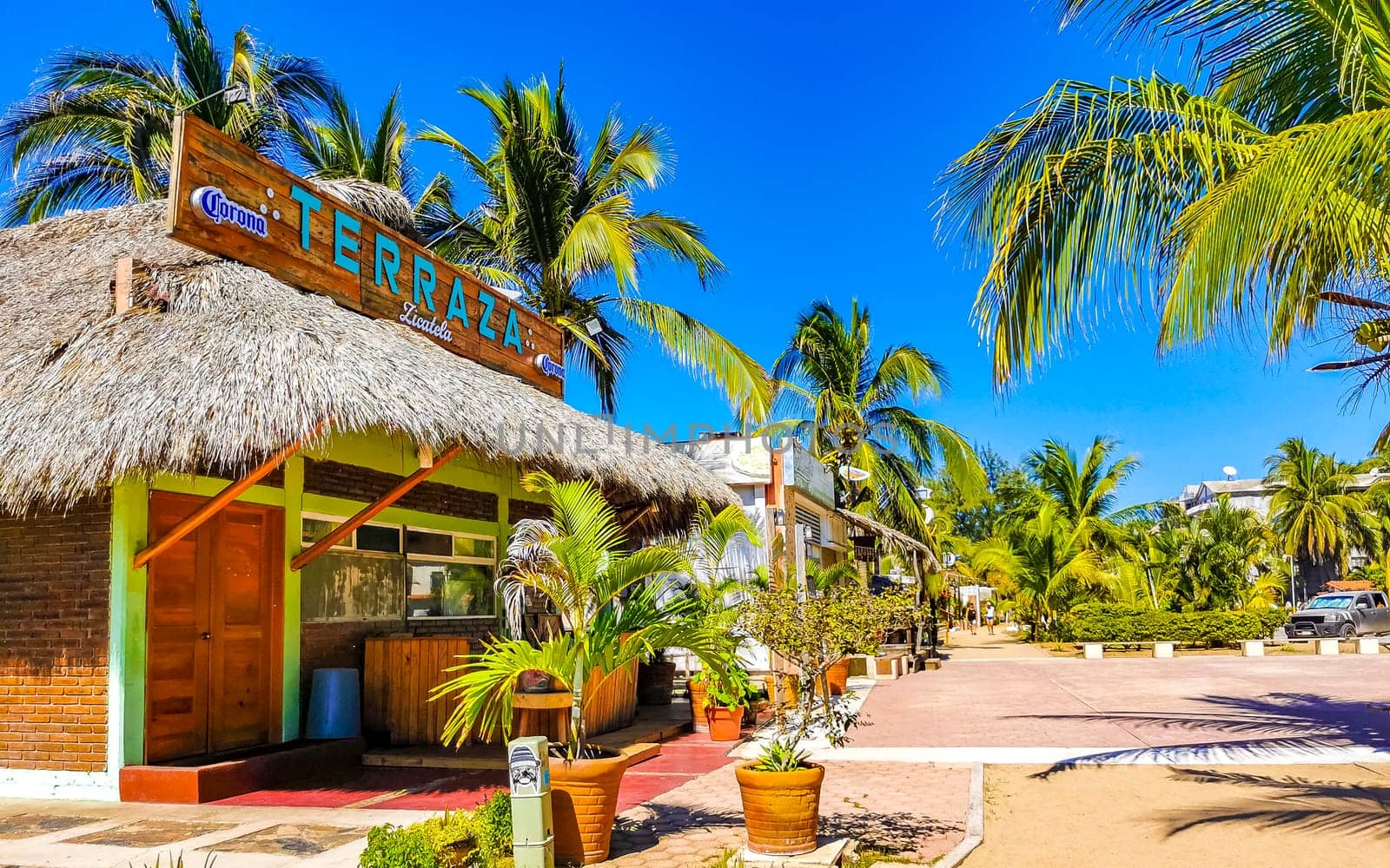 Restaurant hotel palm trees promenade bar on beach Puerto Escondido. by Arkadij