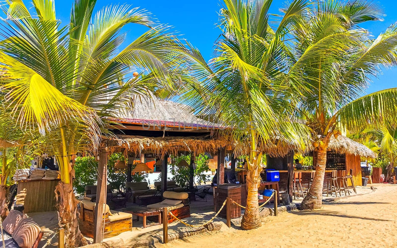 Restaurant restaurants bar bars shops hotels palms palm trees and promenades on the beach in Zicatela Puerto Escondido Oaxaca Mexico.