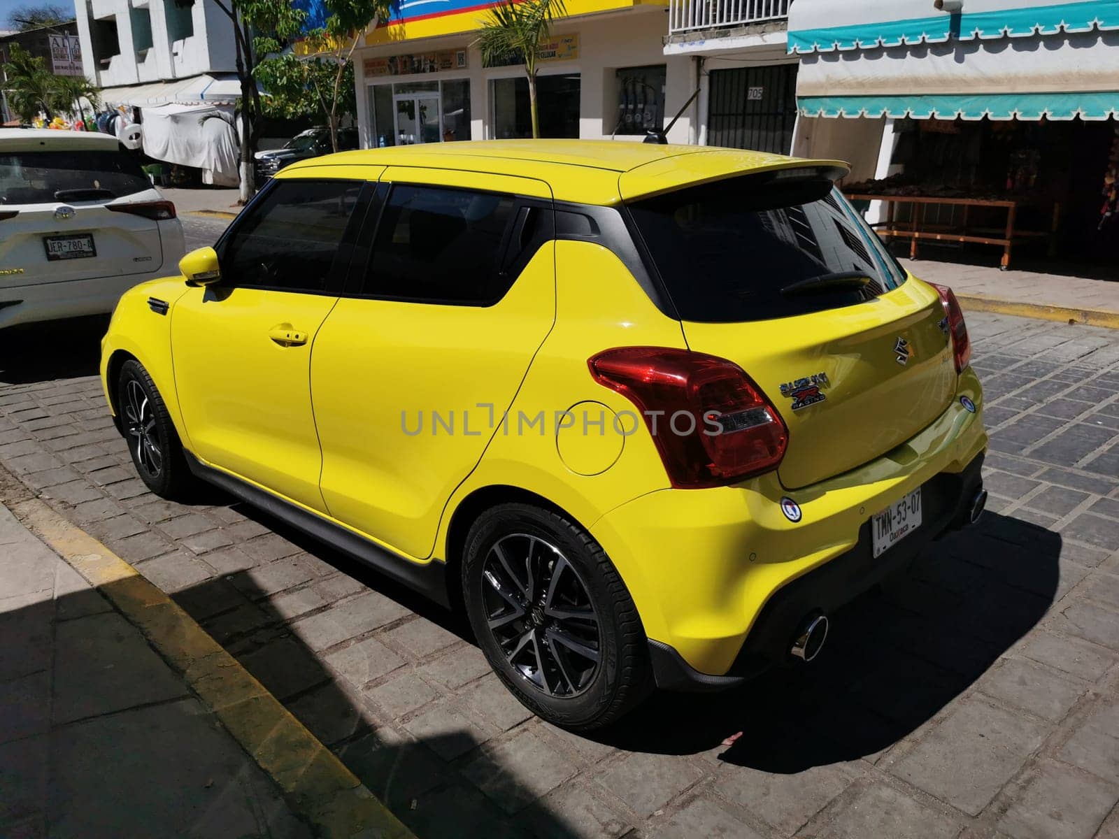 Yellow car vehicle transportation modern in the city town in Zicatela Puerto Escondido Oaxaca Mexico.