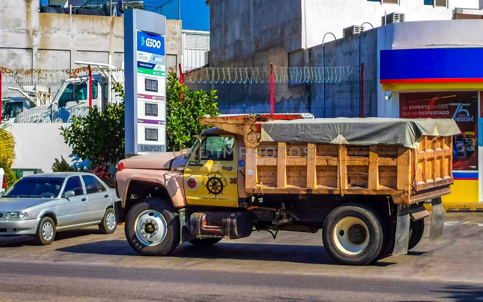 Mexican tipper dumper dump trucks truck cargo transporter delivery cars car vehicles in Puerto Escondido Zicatela Oaxaca Mexico.