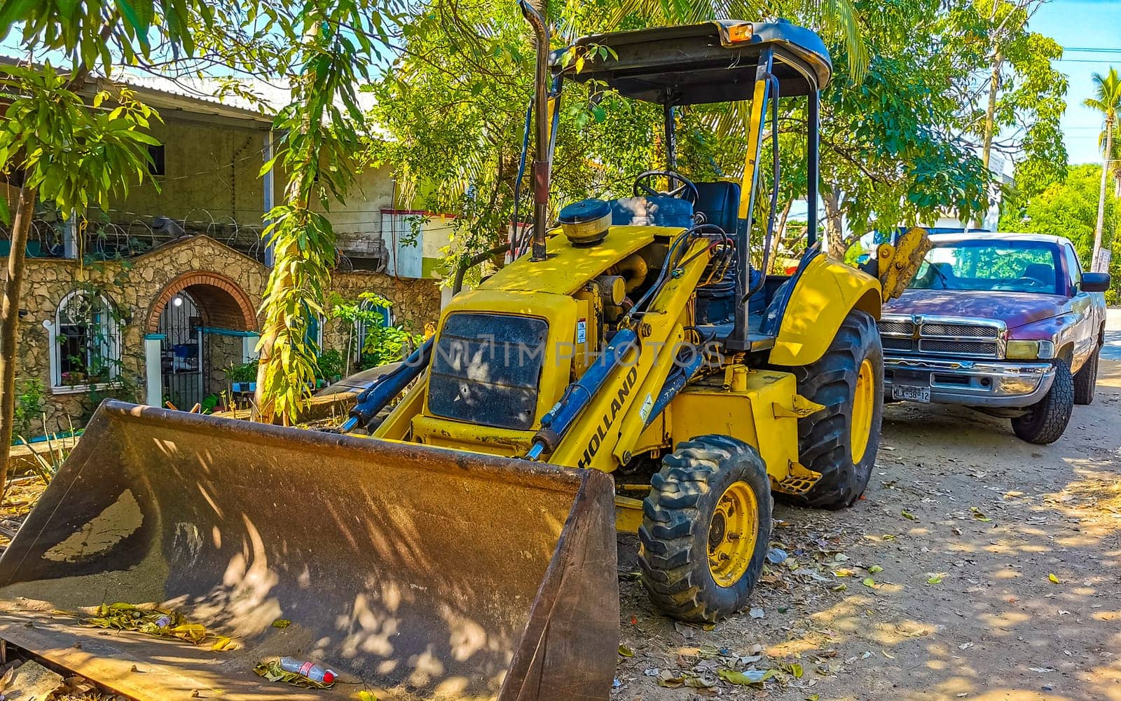 Yellow excavator with shovel in Zicatela Puerto Escondido Oaxaca Mexico.