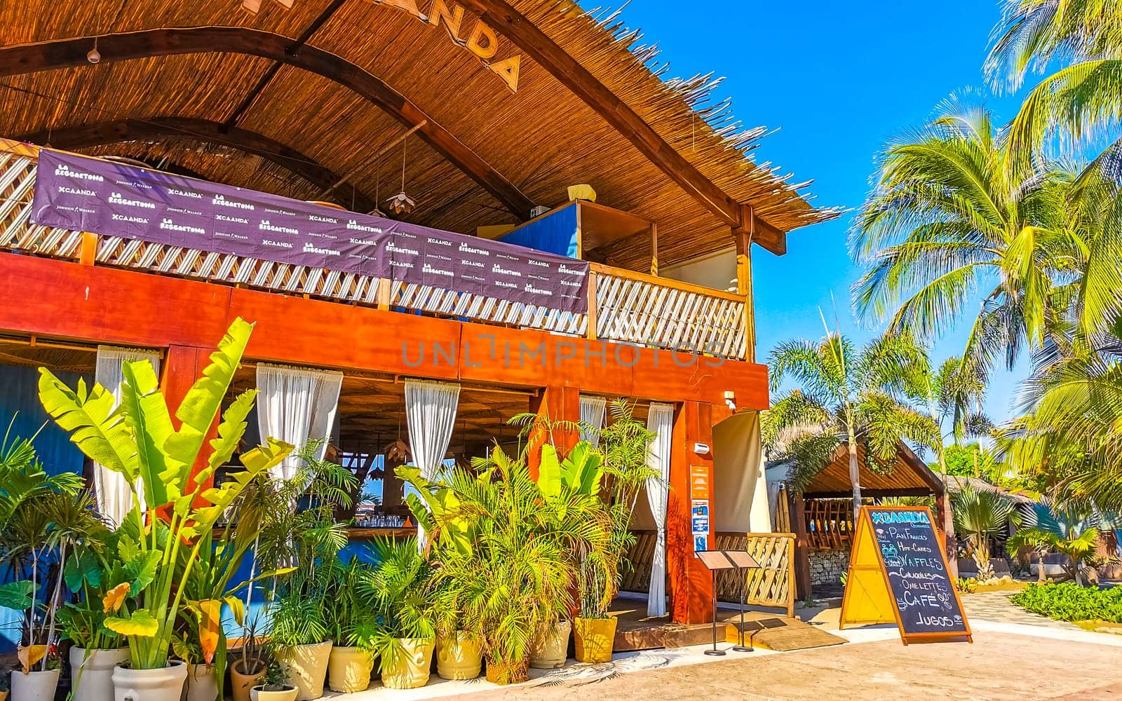 Restaurant restaurants bar bars shops hotels palms palm trees and promenades on the beach in Zicatela Puerto Escondido Oaxaca Mexico.