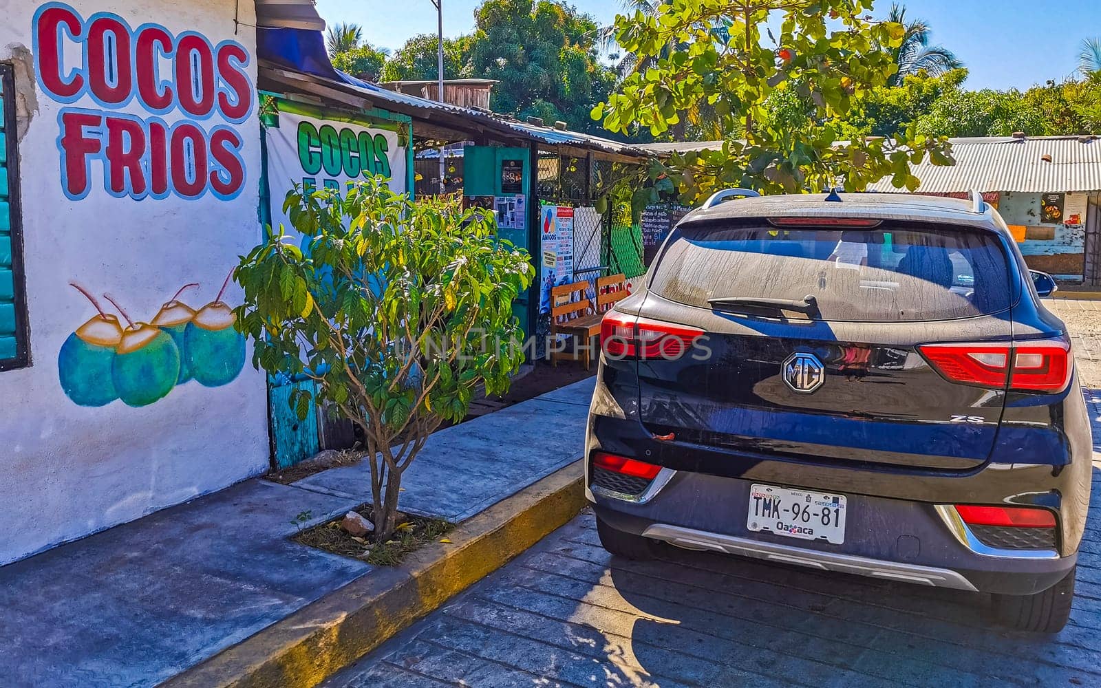 Dark black blue car vehicle transportation in the city town in Zicatela Puerto Escondido Oaxaca Mexico.