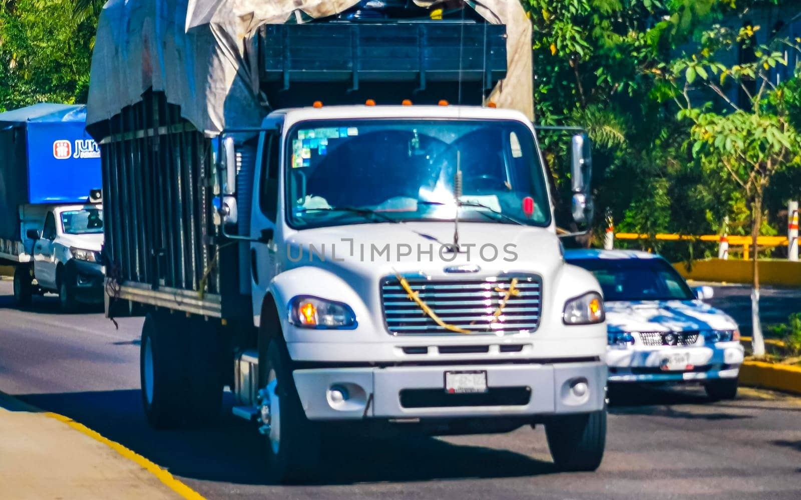 Various Mexican trucks cargo transporter delivery cars in Puerto Escondido zicatela Oaxaca Mexico.