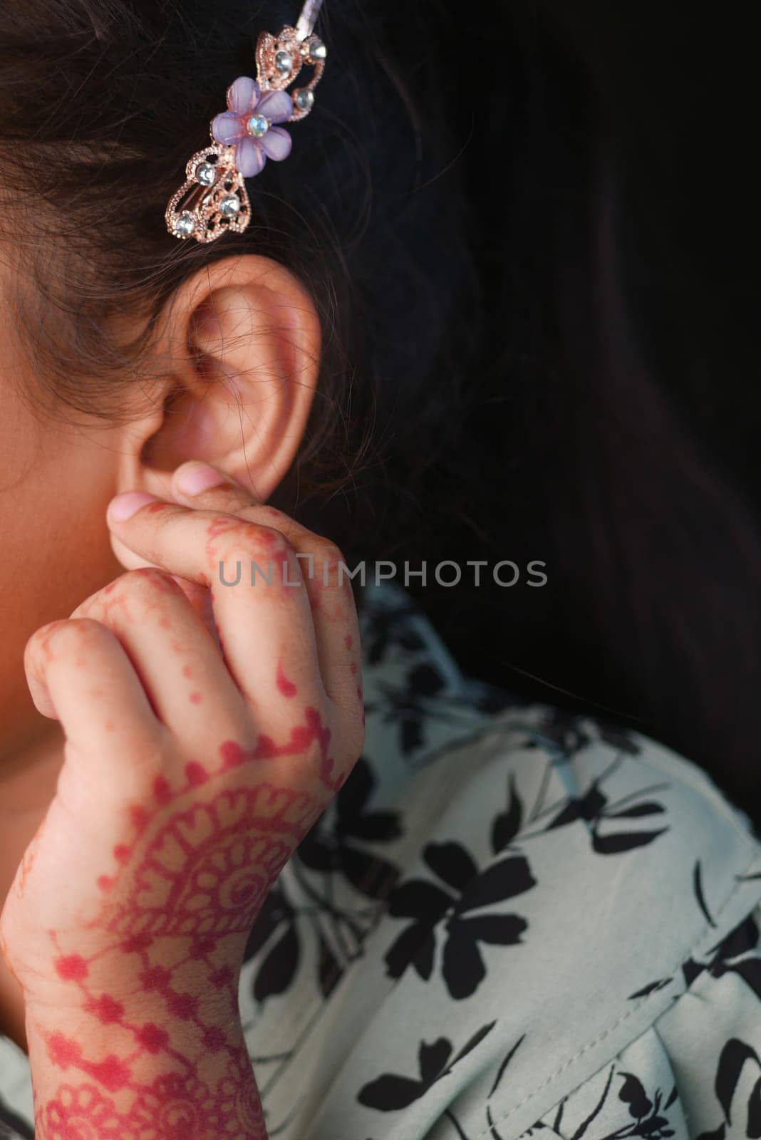 child having ear pain touching his painful ear