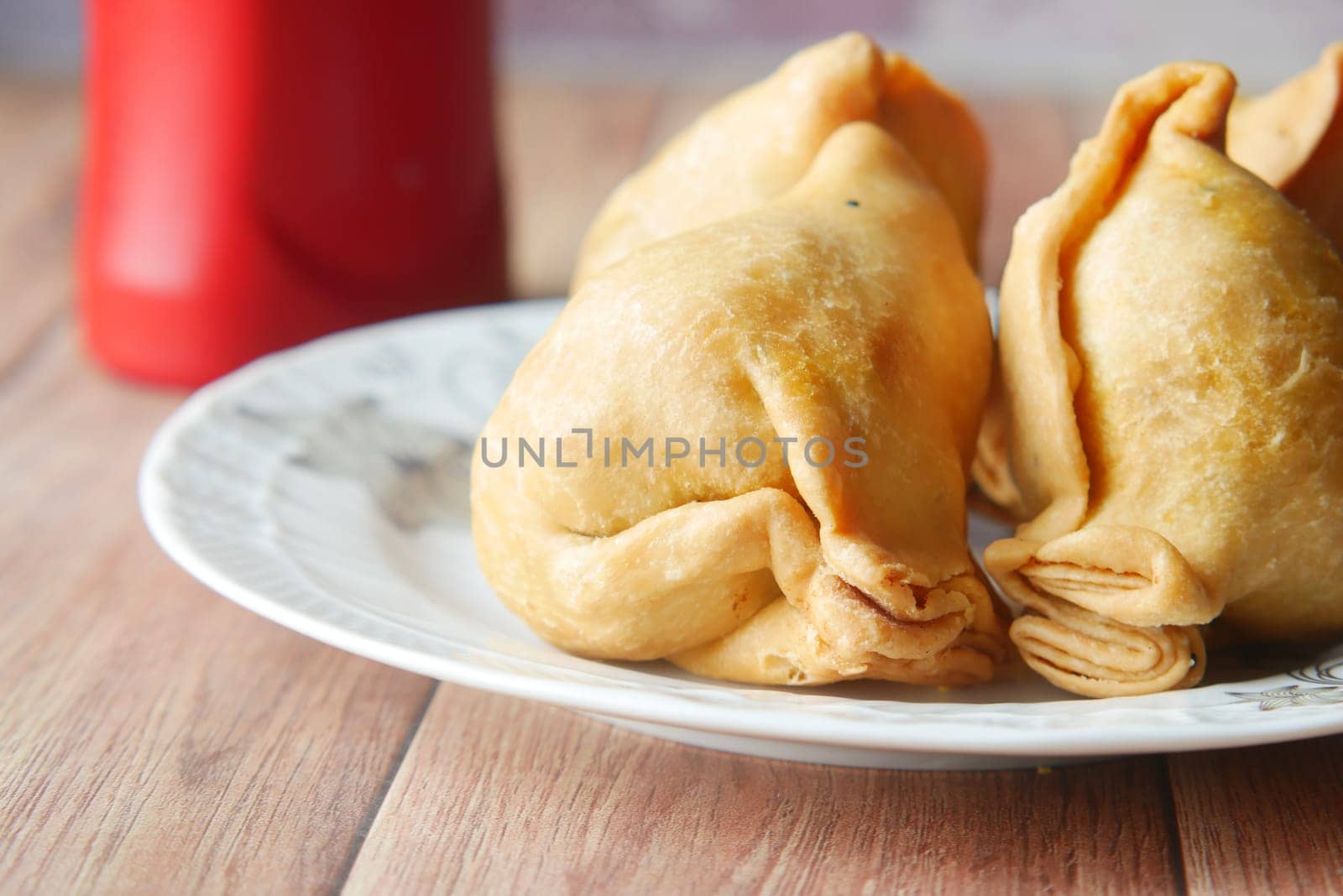 detail shot of a indian food singara on plate .