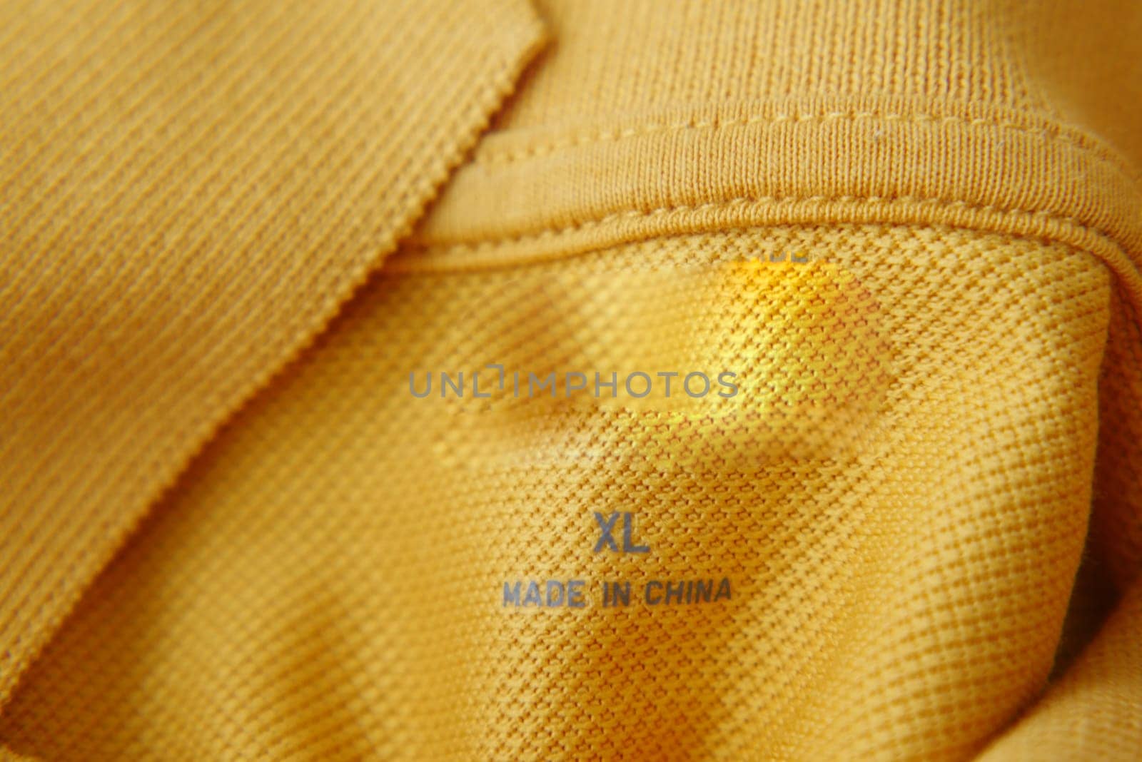 clothing label made in china on a yellow color shirt,