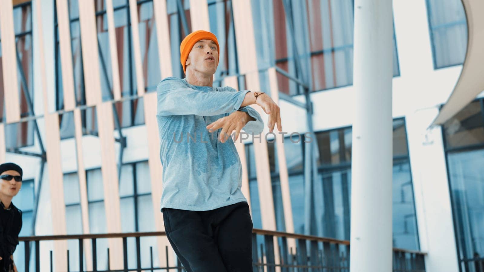 Hipster perform break dancing while partner dancing together at corridor, modern mall. Hip-hop music dancer practice footstep and move to music. Outdoor sport 2024. Active, energetic dance. Endeavor.