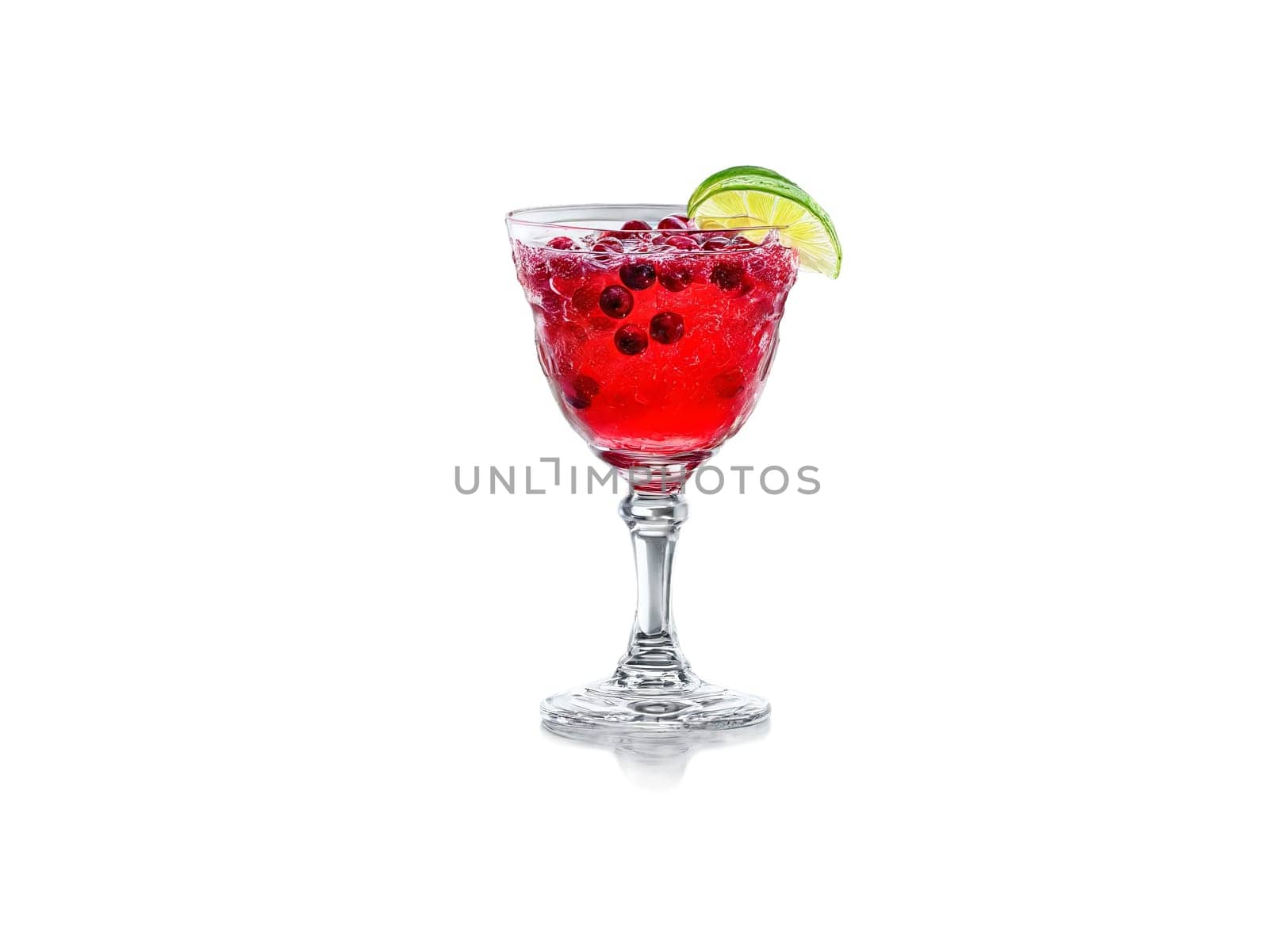 Cranberry soda in a crystal goblet cranberries and lime wedges vibrant red splash in. Drink isolated on transparent background.