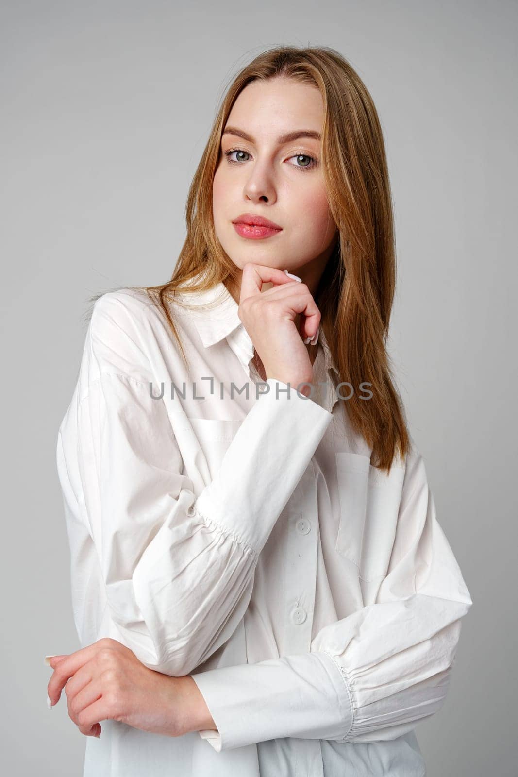 Concerned Young Woman deep in thought or contemplation on gray background