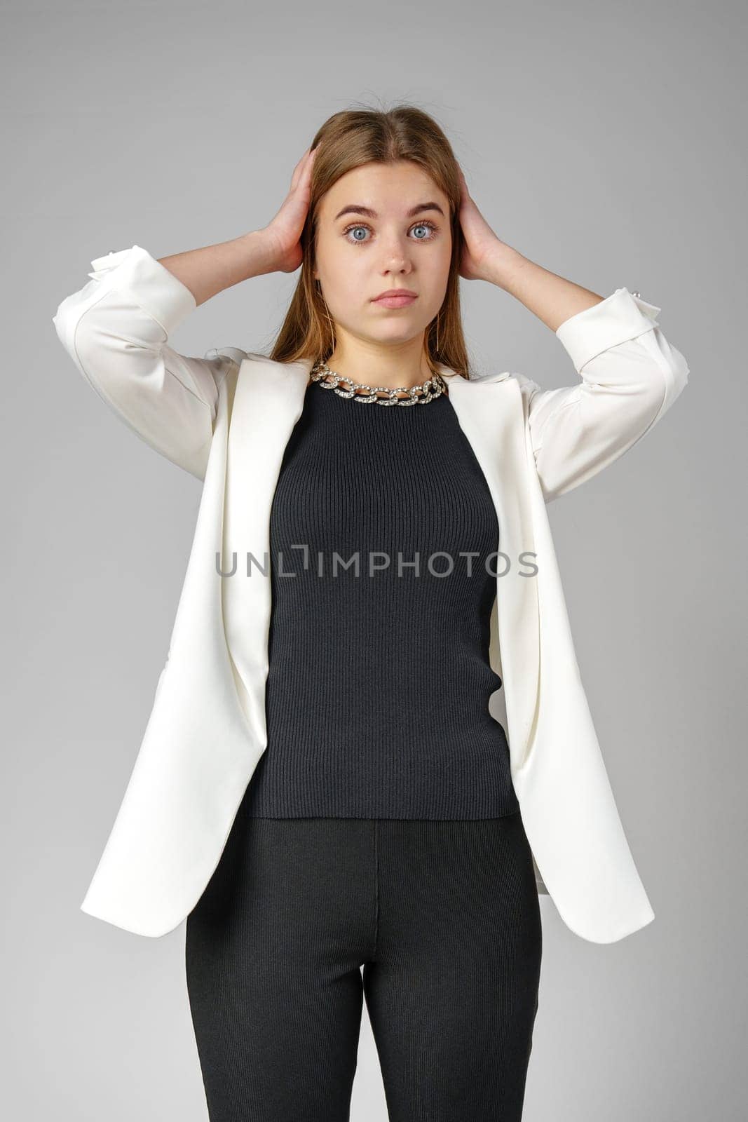 Excited Young Woman in Stylish Outfit Surprised Expression in Studio