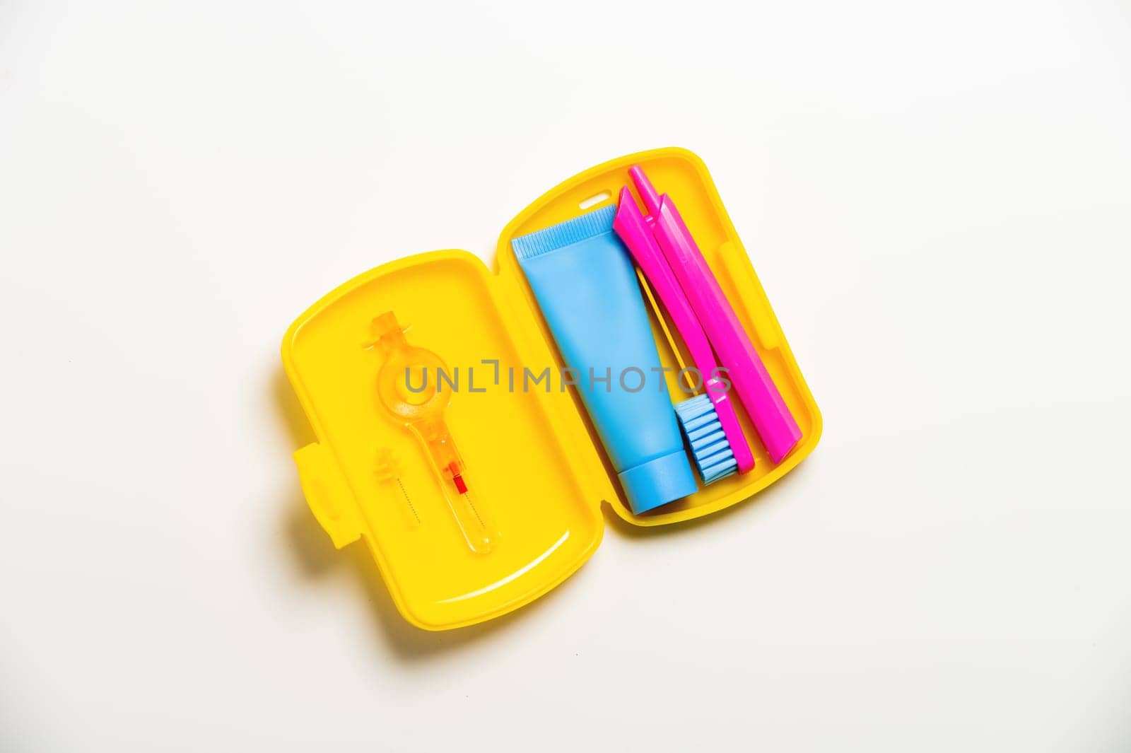 Oral care.Travel set with a toothbrush, toothbrush and toothpaste in a case. Dentist concept. Flat lay, copy space.