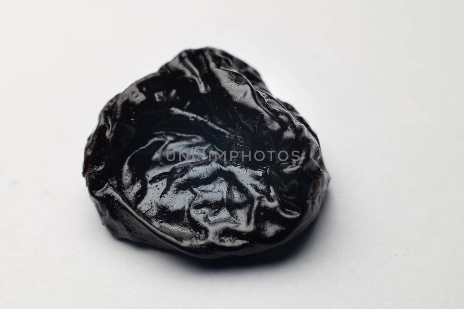 Dried plum, prunes on white background. Clipping Path. Shallow depth of field.