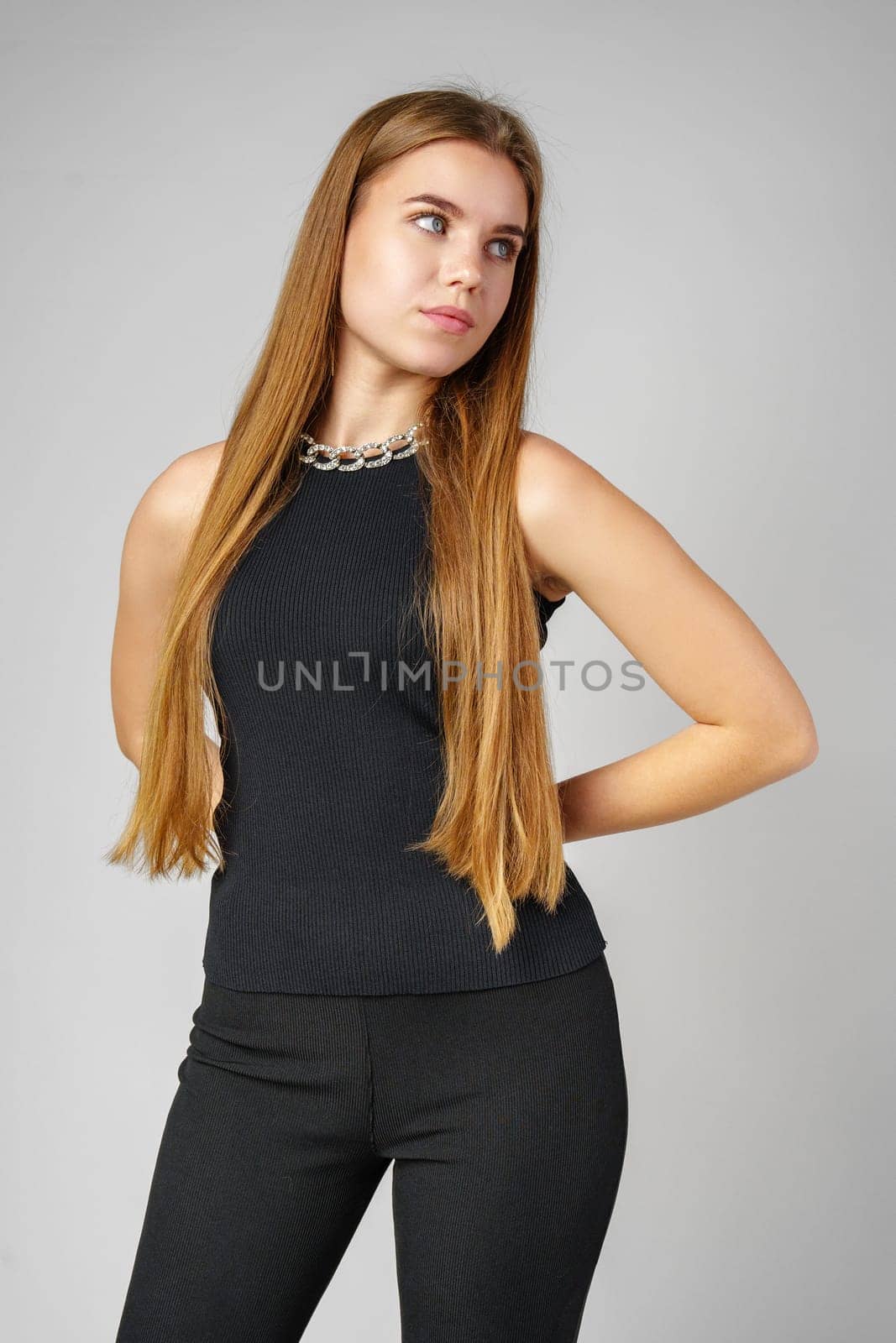 Young Woman With Long Hair in Black Pants and Top