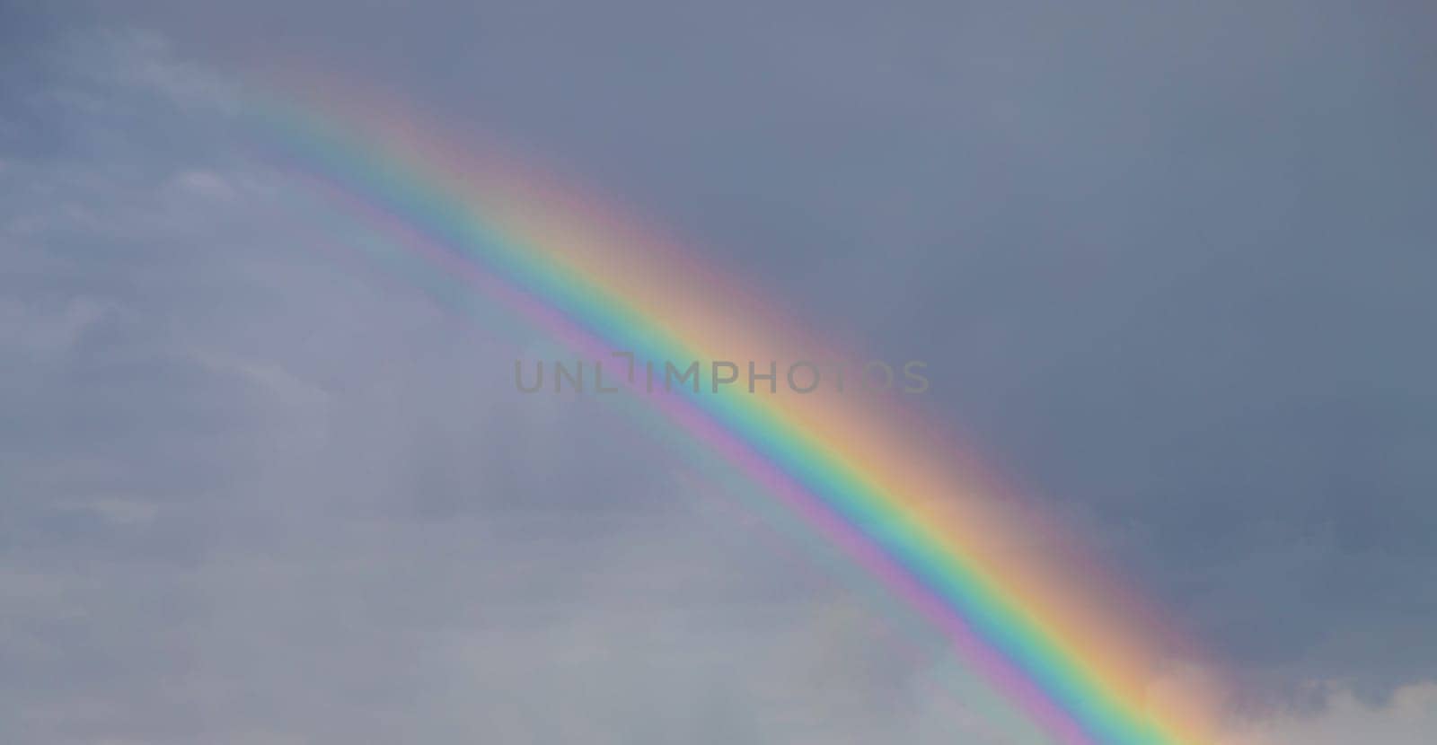 Rainbow in the sky. Selective focus. Rain summer,