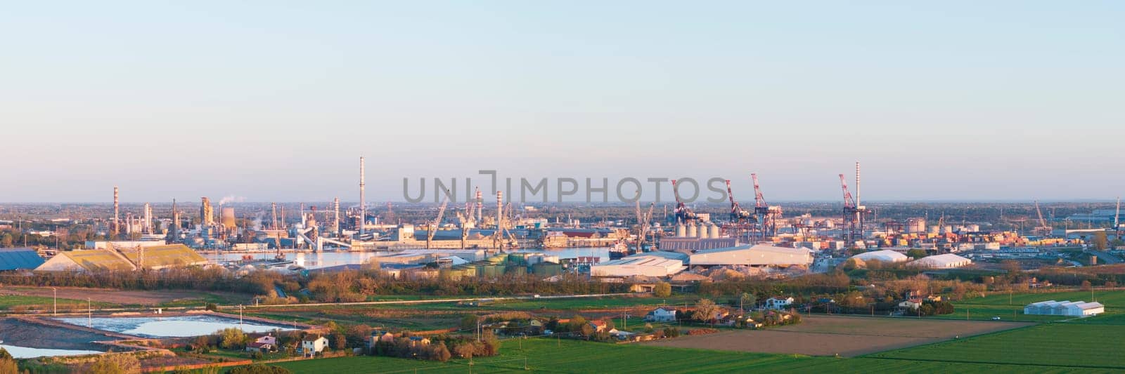 Aerial view of the industrial and port area of Ravenna ,chemical and petrochemical pole,thermoelectric,metallurgical plants and hydrocarbon refinery and liquefied natural gas tanks