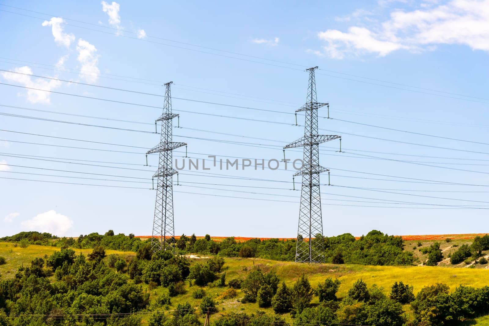 High voltage towers Electric pole. Power line support with wires for electricity transmission. High voltage grid tower with wire cable at distribution station. Energy industry, energy saving by Matiunina