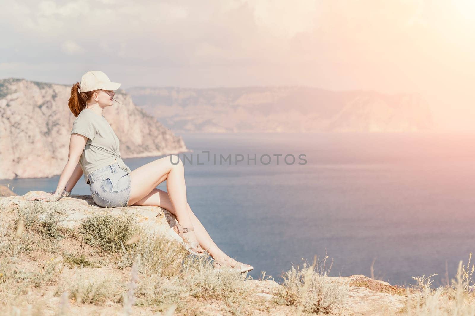 Woman travel sea. Happy carefree sensual woman with long hair in black swimwear posing at sunset beach. Silhouette of young beautiful playful positive woman outdoor. Summer vacation and trip concept