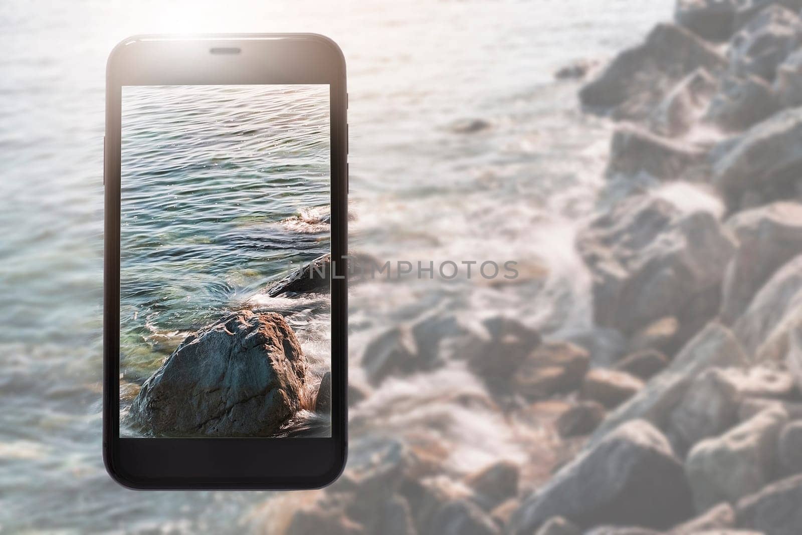 Phone layout on background of clear waters and a rocky beach.