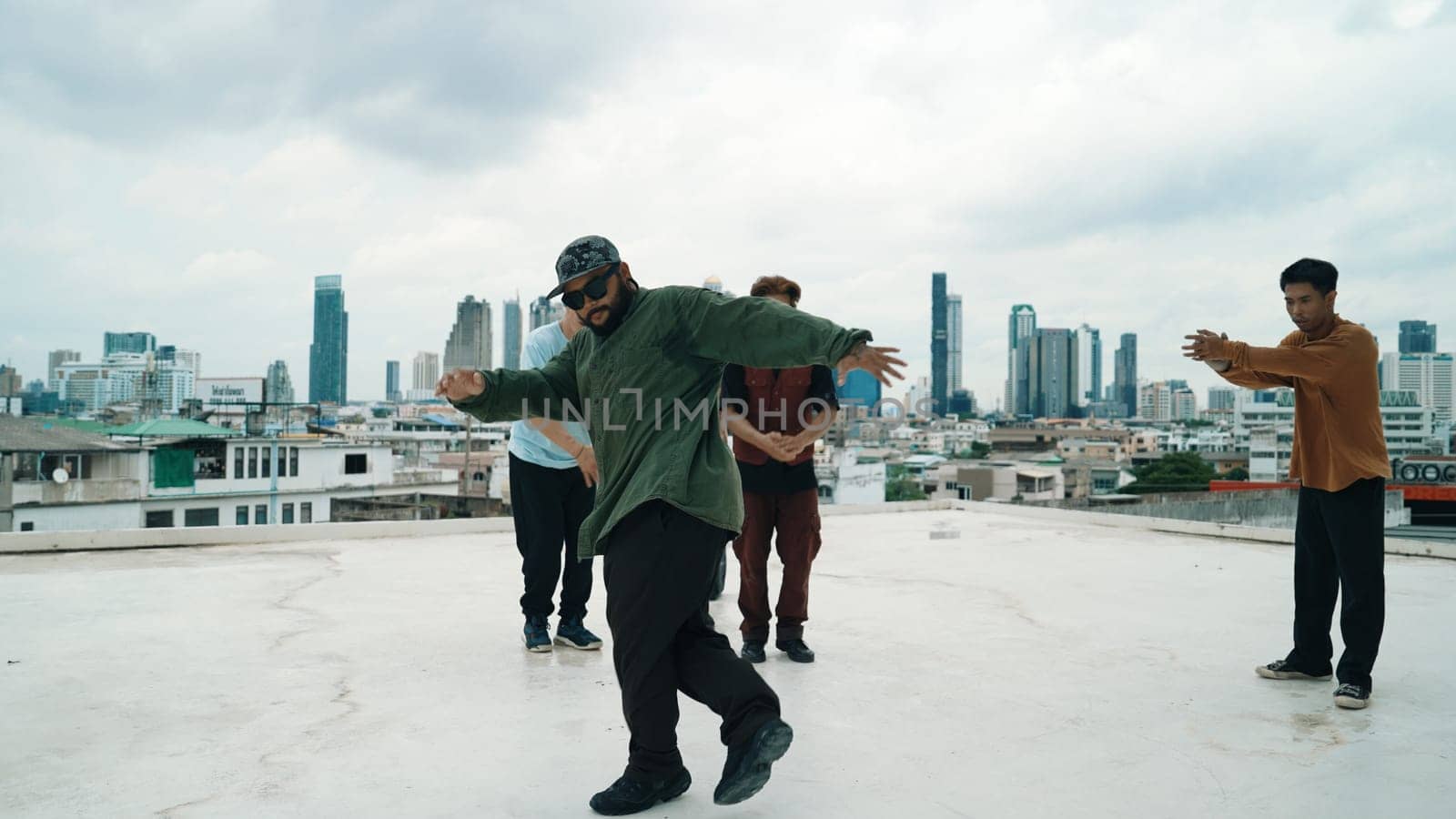 Profession break dancer practice B-boy dance with friends at roof top. Endeavor. by biancoblue