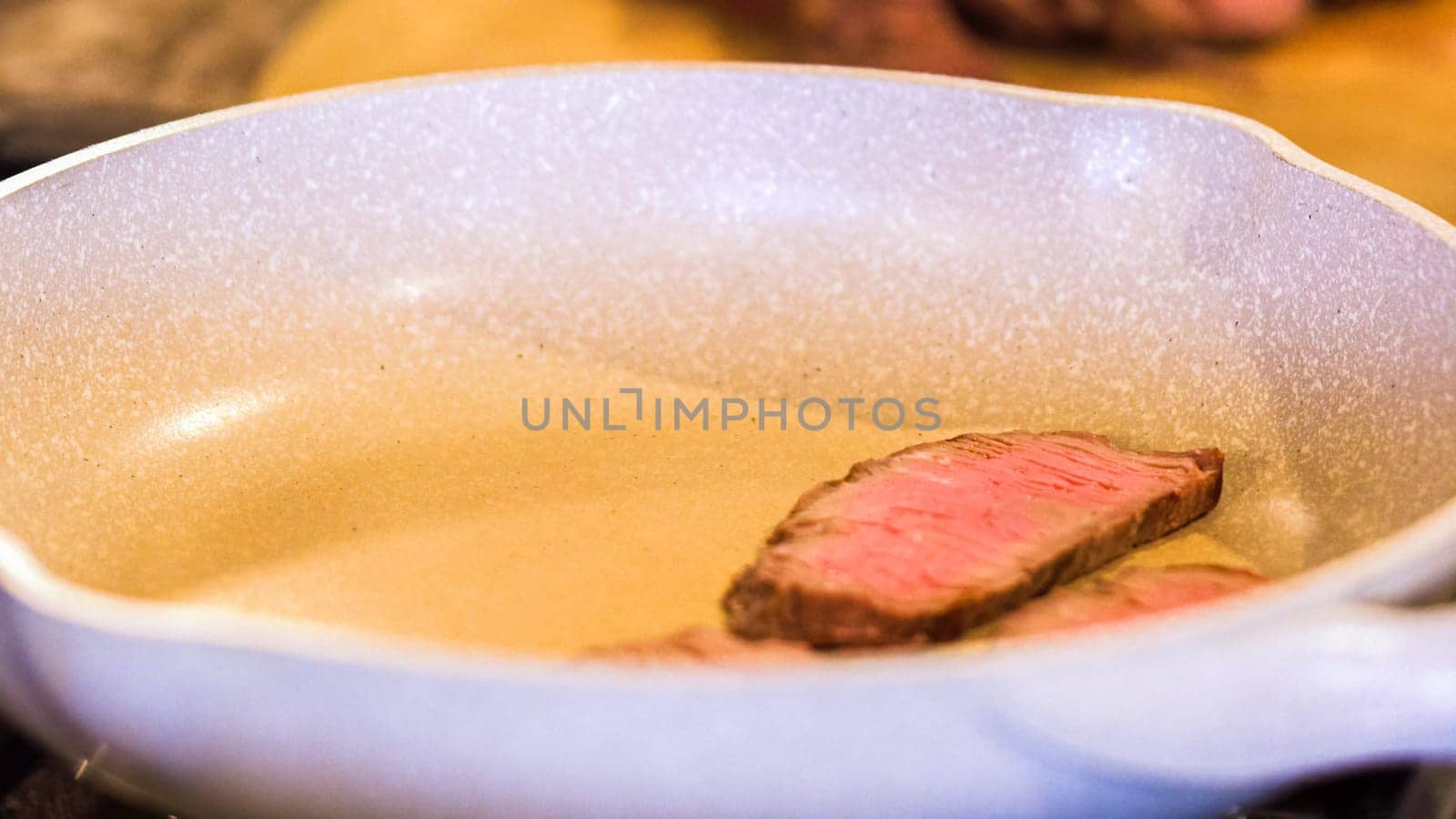 Searing Steak Slices in Marbled White Pan by arinahabich