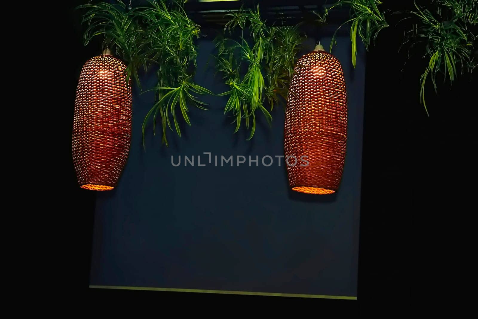 Glowing electric lamps in a wicker lampshade at dusk.Board for text by jovani68