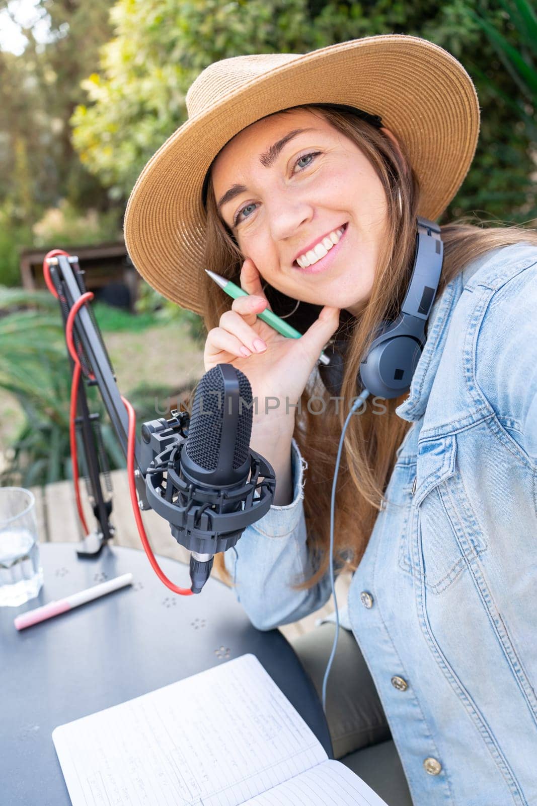 Selfie portrait happy smiling young woman with headphones recording podcast. by PaulCarr