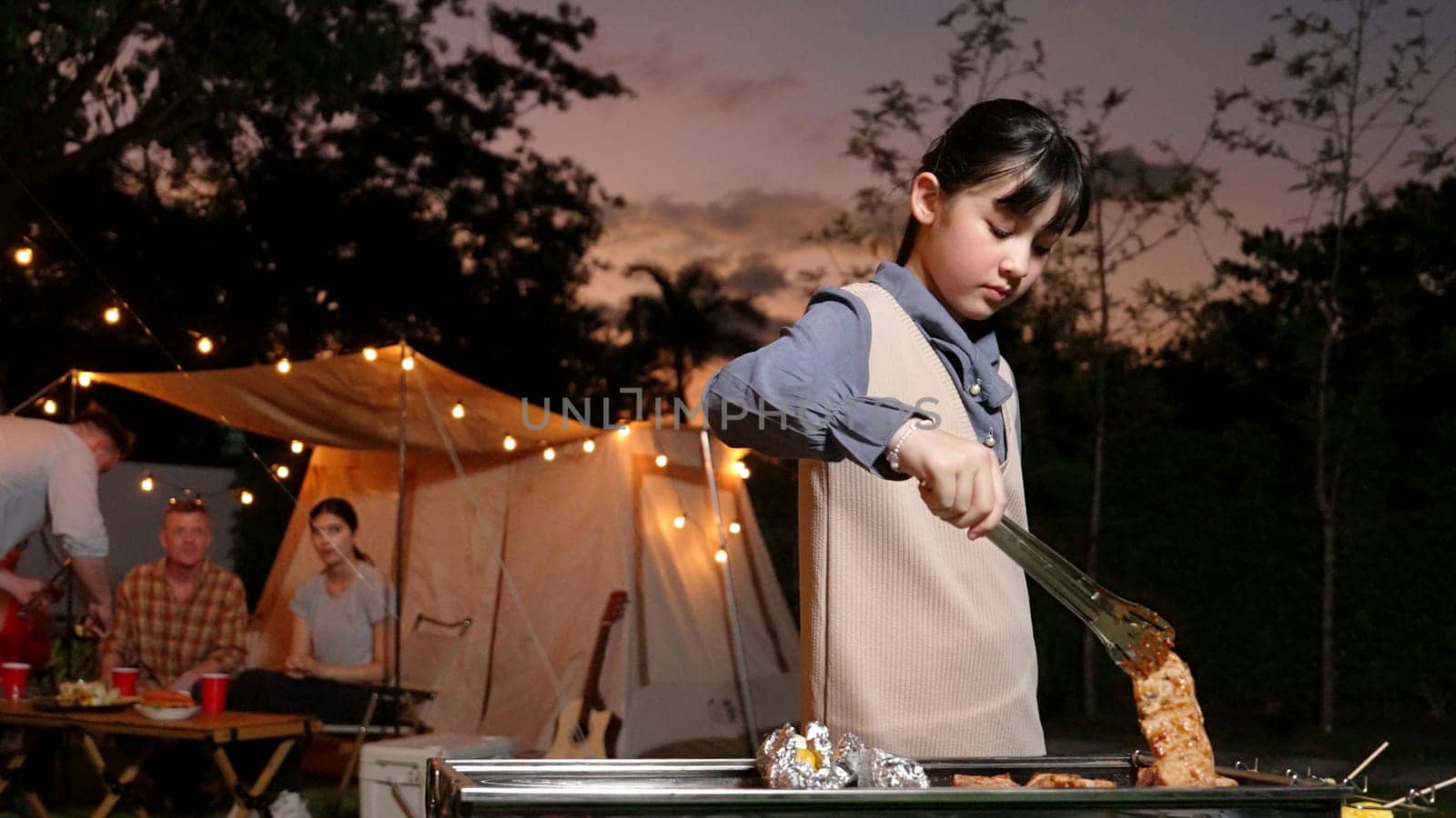 Family gather celebrate holiday, Adorable child grill food for family member. Outdoor camping activity to relax with tasty meal and spend time with young generation cross generation gap. Divergence.