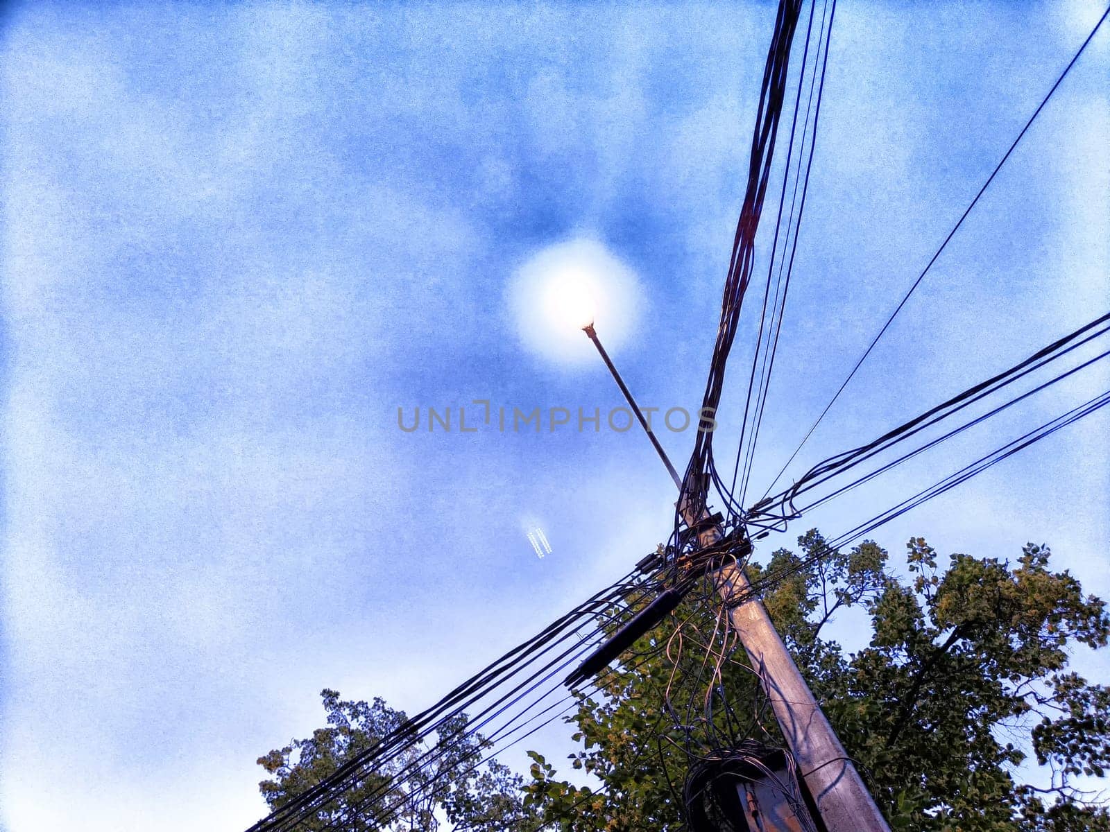 Old pole with wires against the sky. Electric transmission line, Eco-friendly energy