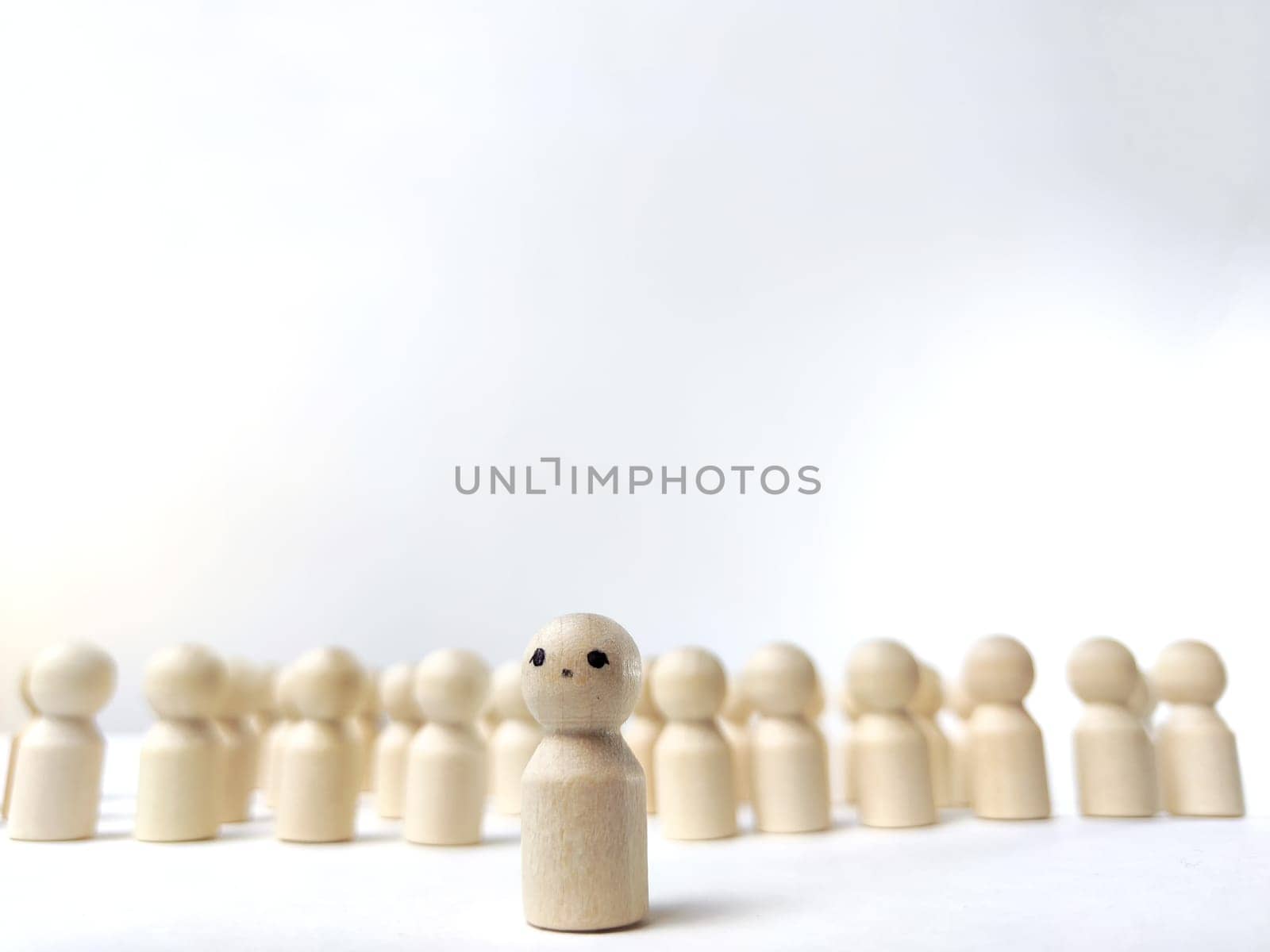 Wooden figurines with a leader and a group. Different, independent, sighted, determined, at head of group. Leadership concept, manager, influencer, CEO, market, opinion leader and business leader