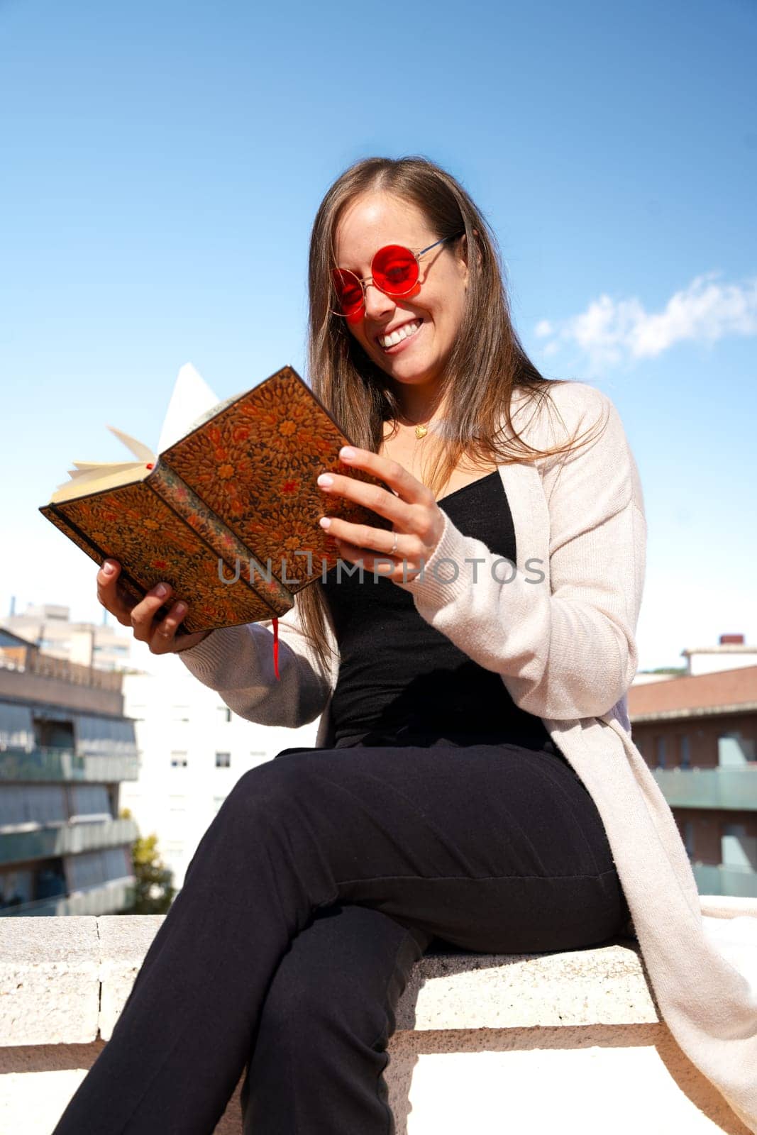 A concentrated Caucasian woman reads a book.