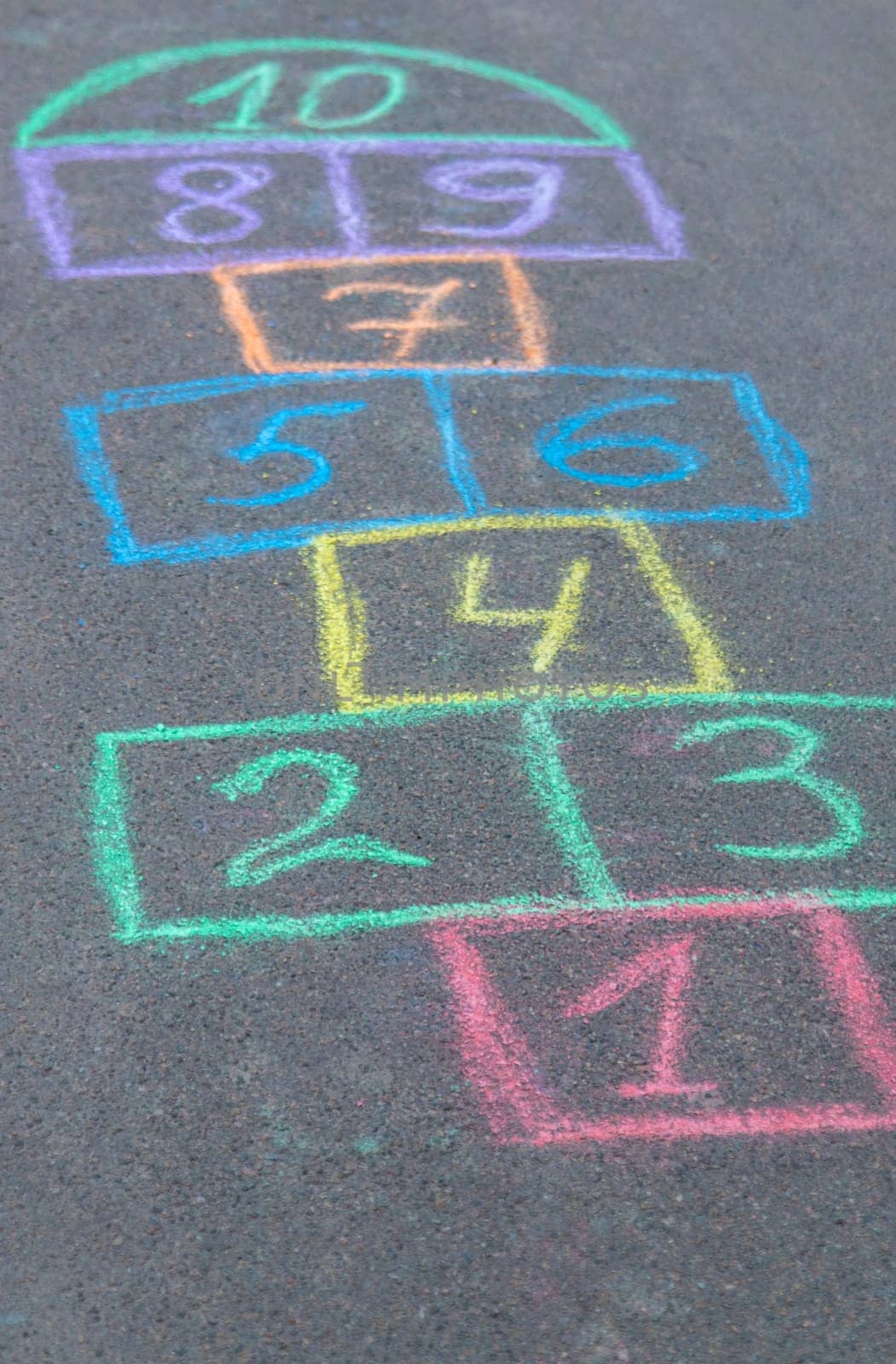 Children play hopscotch on the street. Selective focus. Nature.