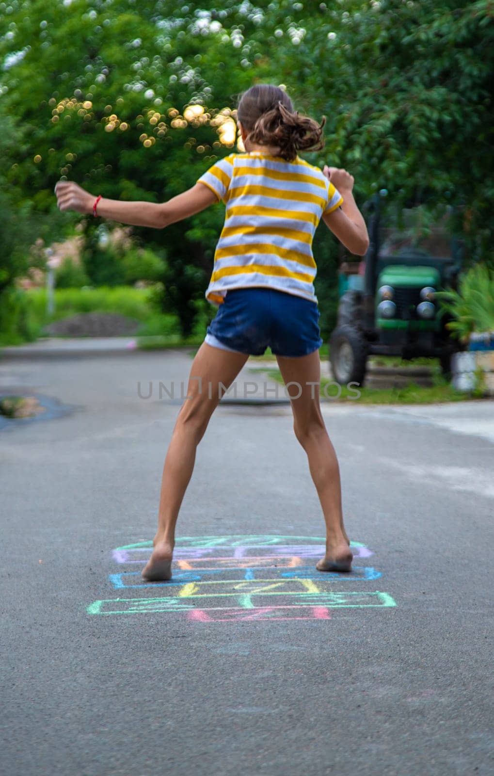 Children play hopscotch on the street. Selective focus. Nature.