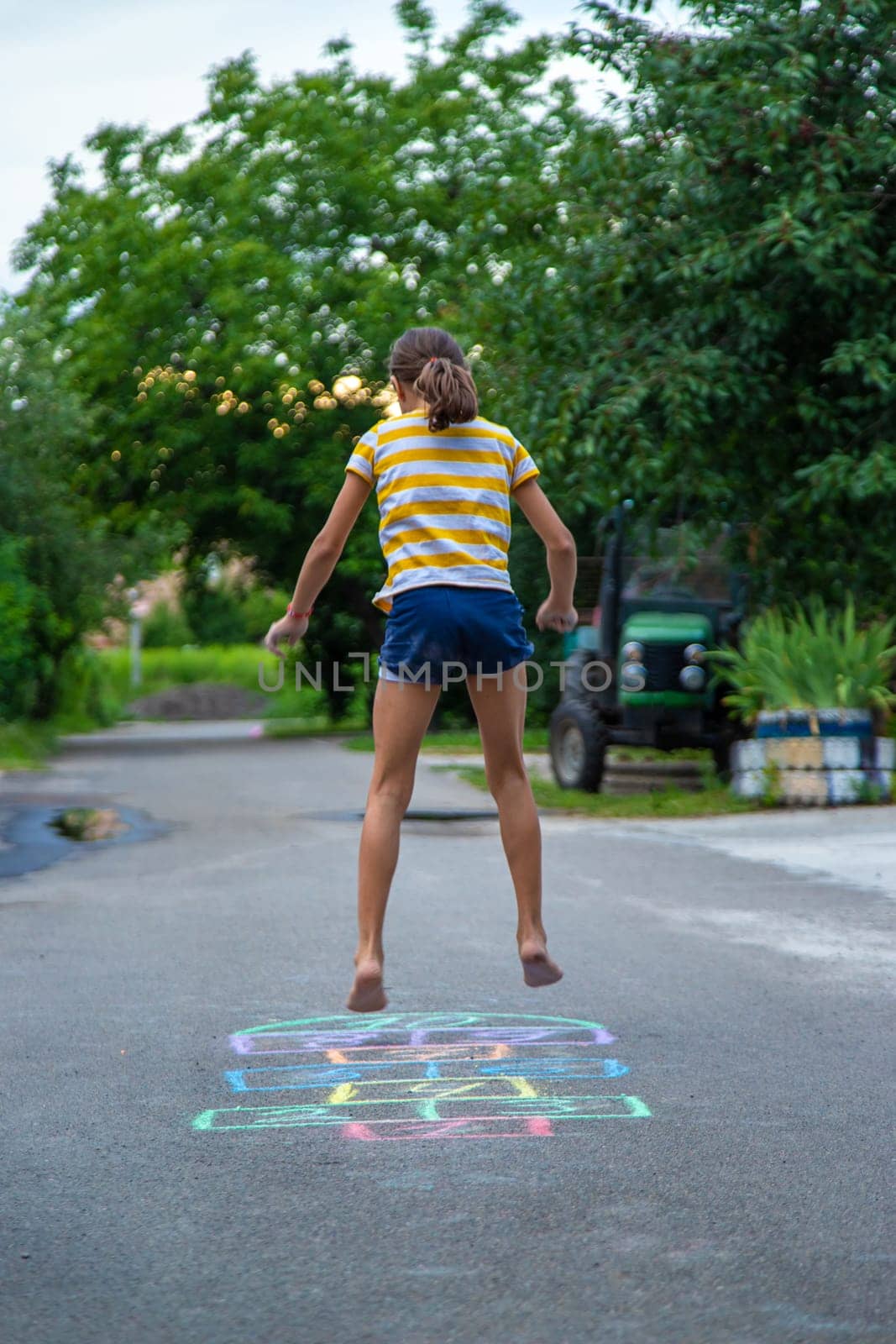 Children play hopscotch on the street. Selective focus. Nature.