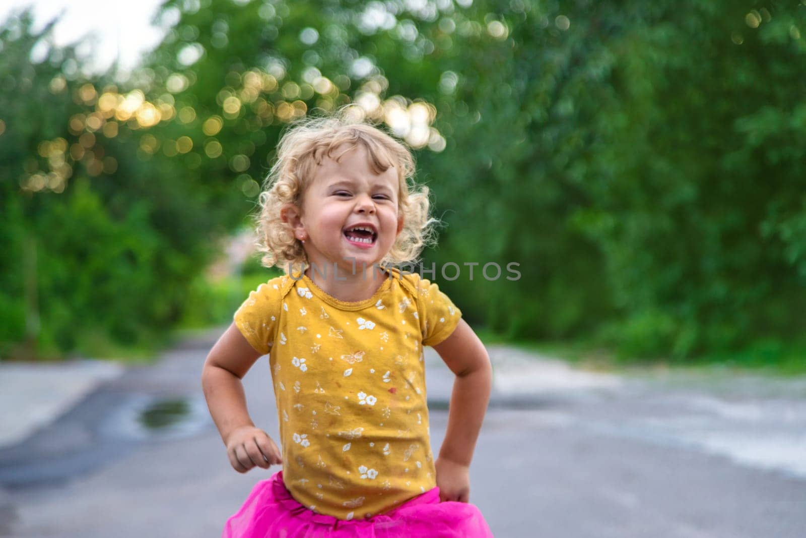 Cheerful child on the street portrait. Selective focus. Kid.