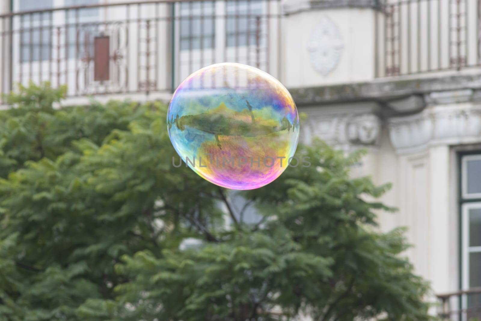 A big soap bubble on the street. Mid shot