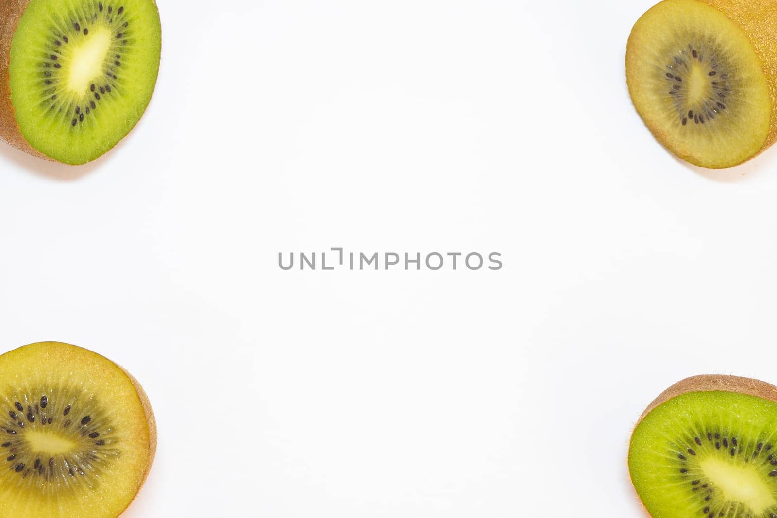 Mix of green and yellow kiwi's cut in half, on a white background.
