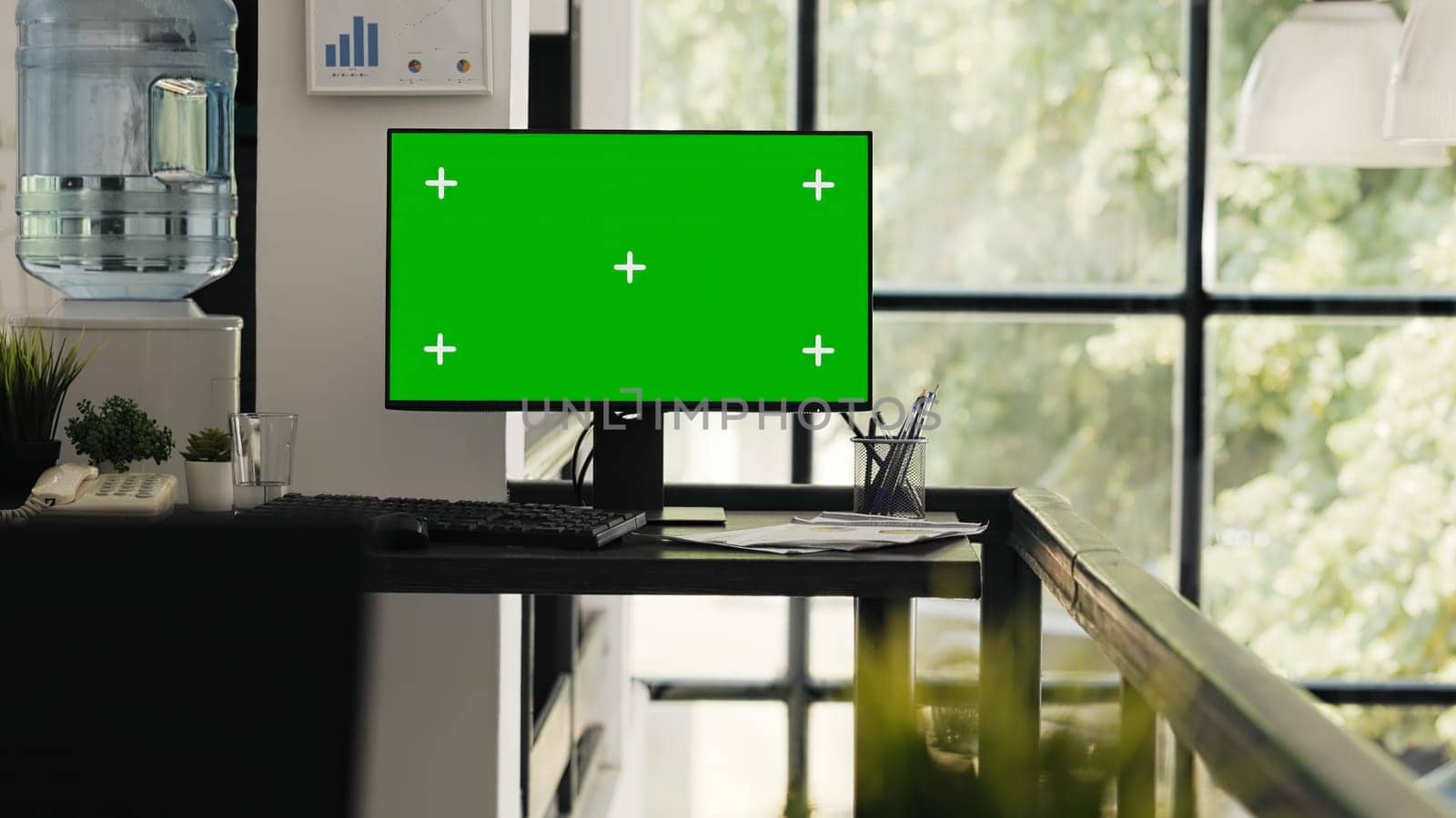 Empty desk with greenscreen layout presenting blank copyspace template in agency coworking space. Office workstation running computer monitor with isolated chromakey screen, modern software.