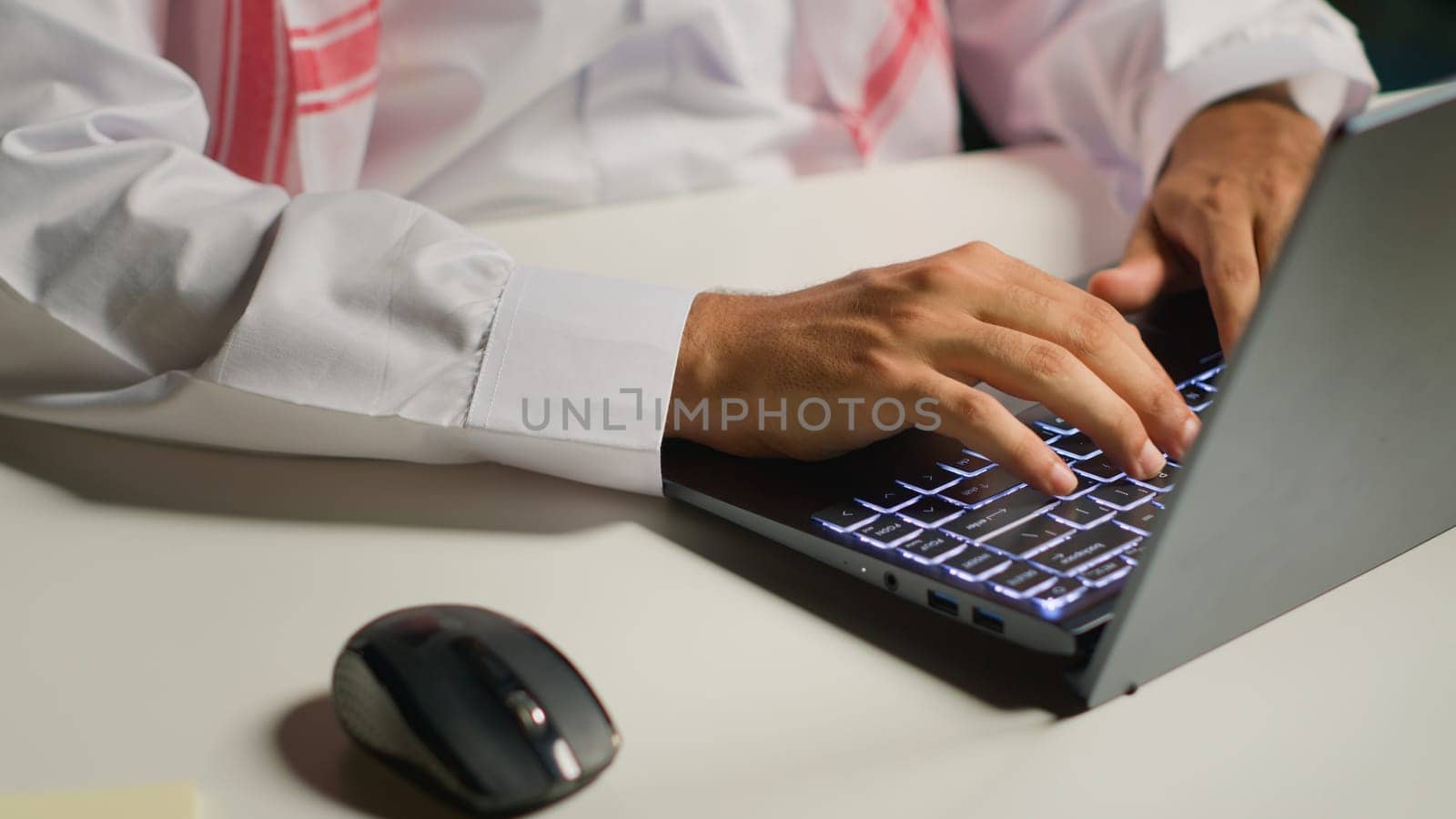 Close up shot of businessman using laptop and mouse in office to solve various work tasks. Employee typing on notepad keyboard in order to deliver finalized project paperwork to management