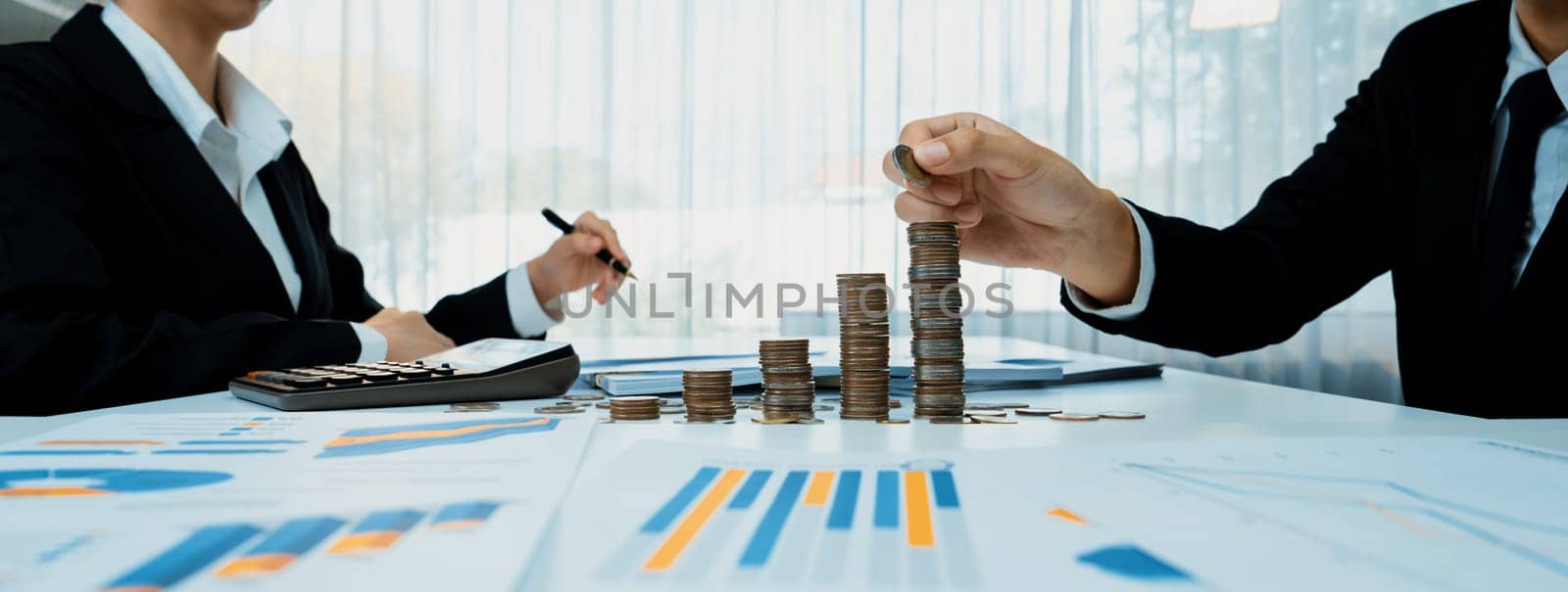 Growth coin stack symbolizing business investment and economic growth. Business people doing financial planning to achieve financial goal and contribute maximum profit gain . Shrewd