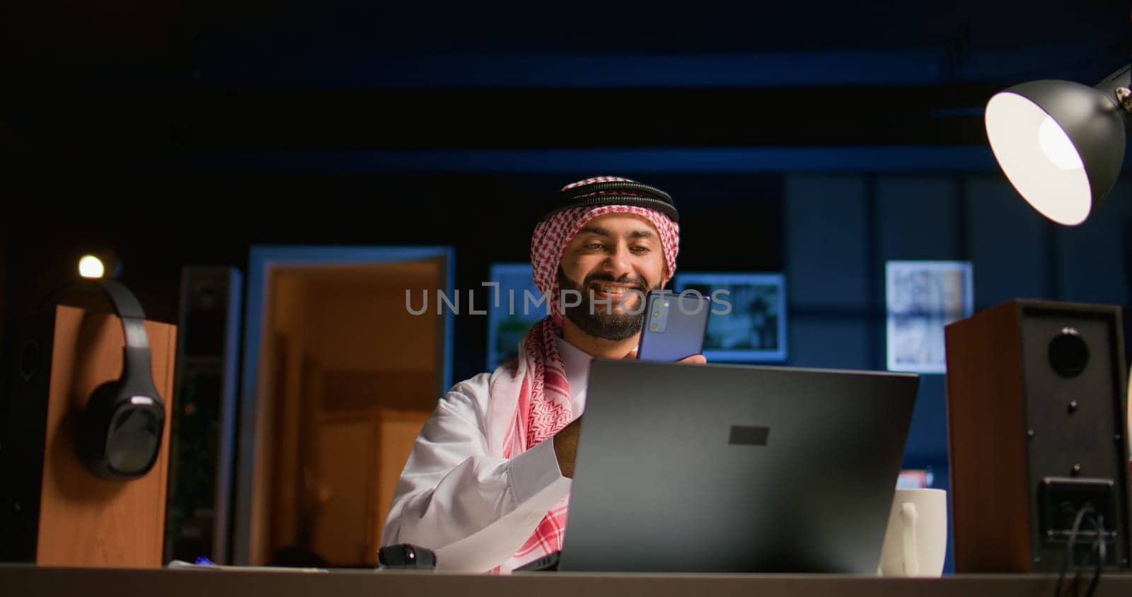 Arabic man checking up on abroad living friend during video conference meeting over the internet. Muslim person enjoying time together with mate in online video call session while at home