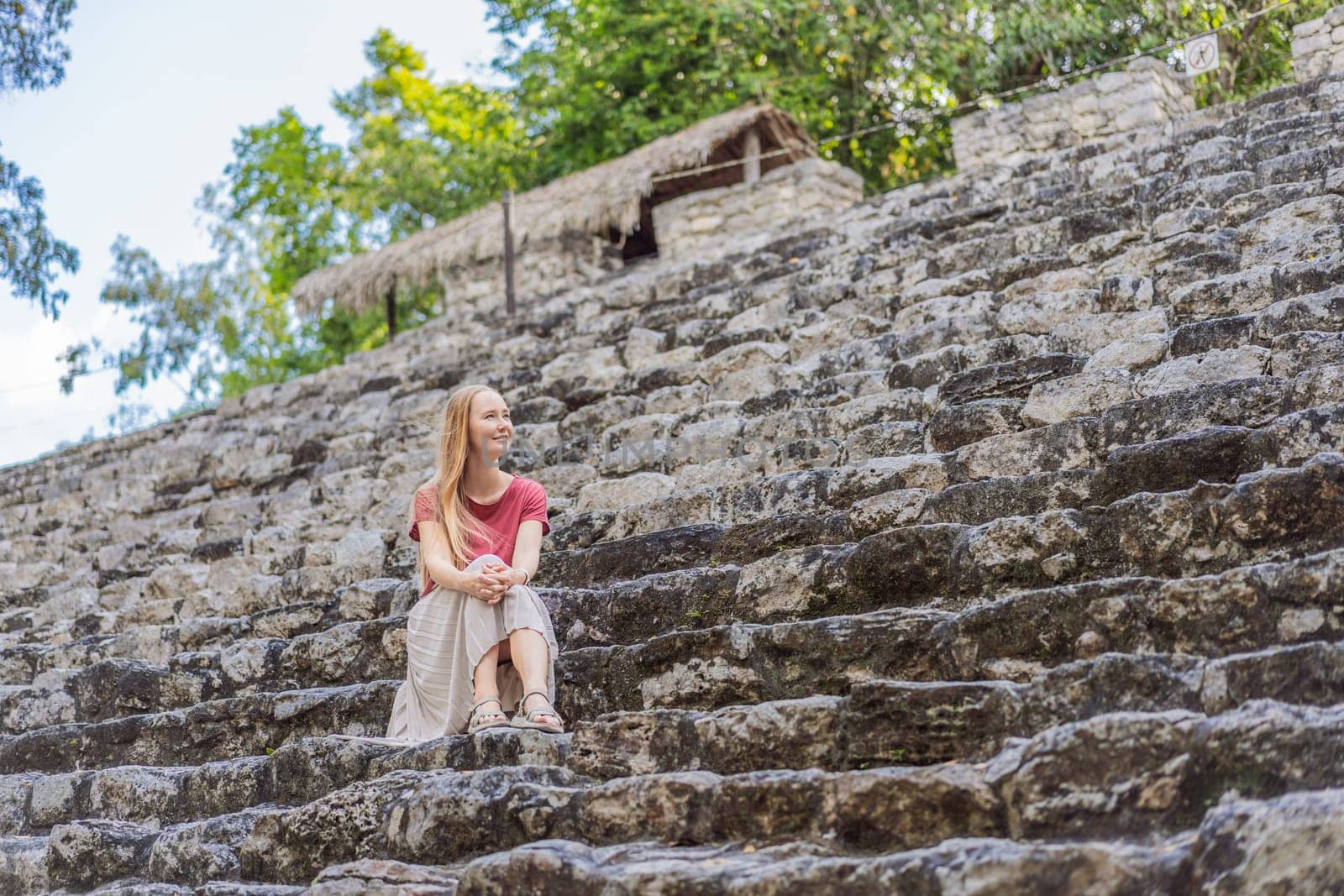 Woman tourist at Coba, Mexico. Ancient mayan city in Mexico. Coba is an archaeological area and a famous landmark of Yucatan Peninsula. Cloudy sky over a pyramid in Mexico by galitskaya