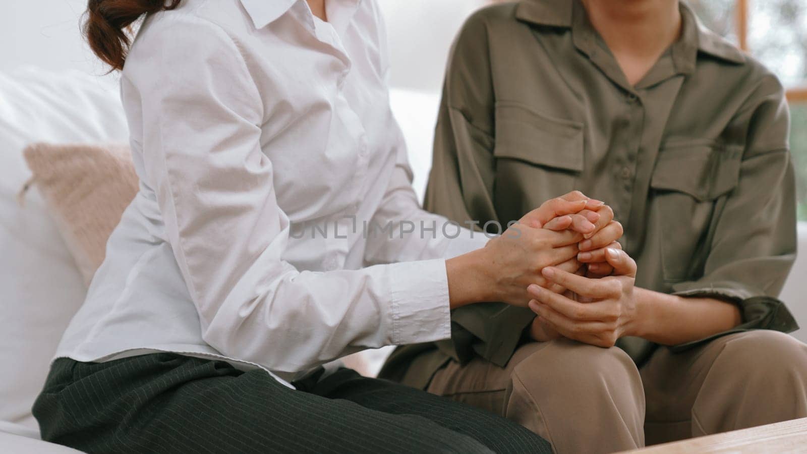 Supportive and comforting hands cheering up depressed patient person or stressed mind with empathy. Psychologist reassuring stressful and sad patient in vivancy clinic.
