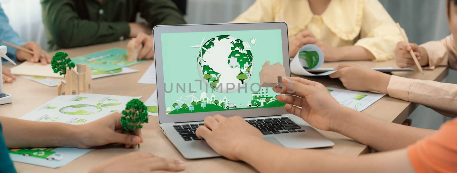 Green city logo displayed on a laptop at a green business meeting. Team presenting green design to customer. ESG environment social governance and Eco conservative concept. Closeup. Delineation.