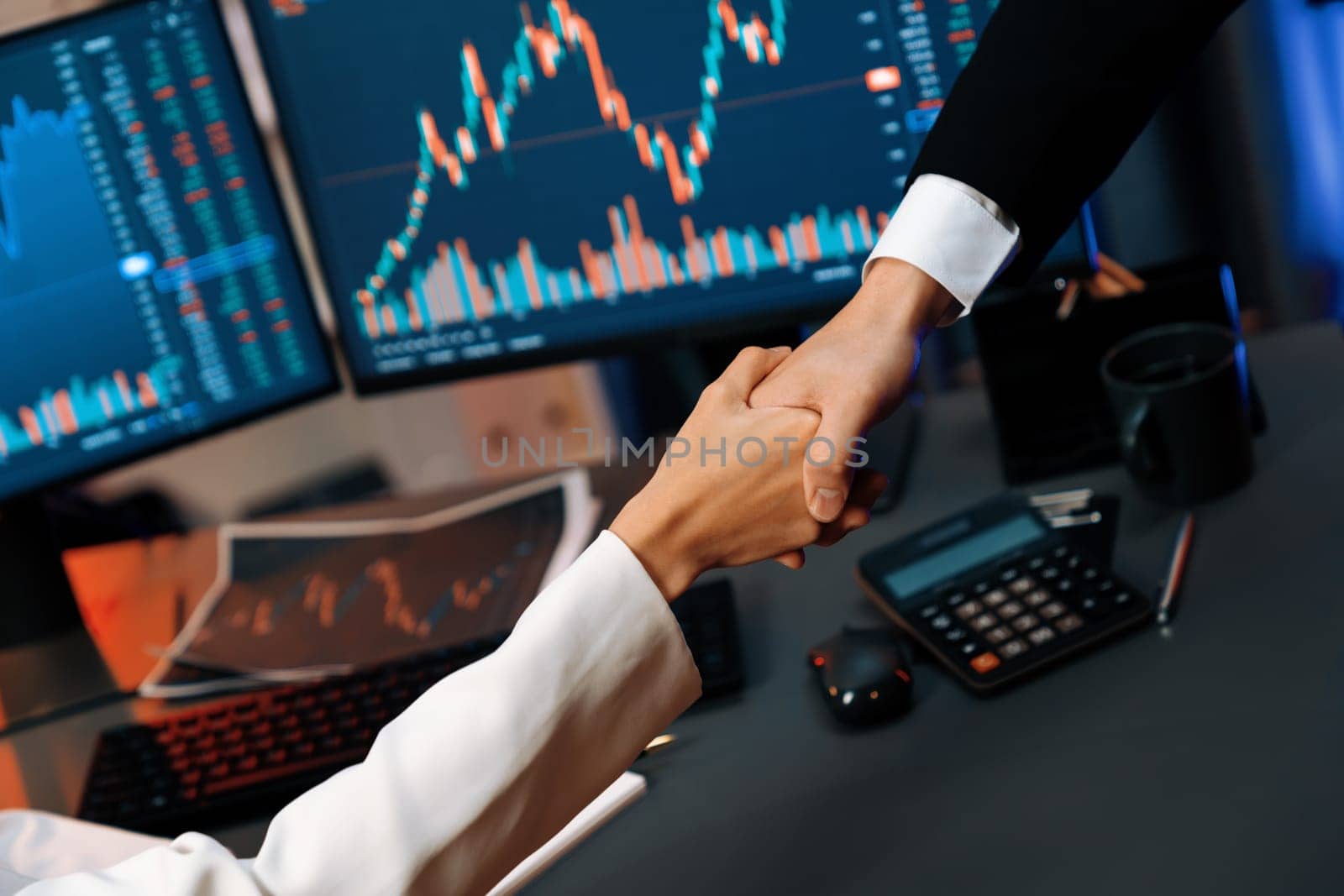 Cropped hand of business partner checking hand with dynamic stock market data analyzing profit value currency rate online website program application background pc screen at modern office. Infobahn.
