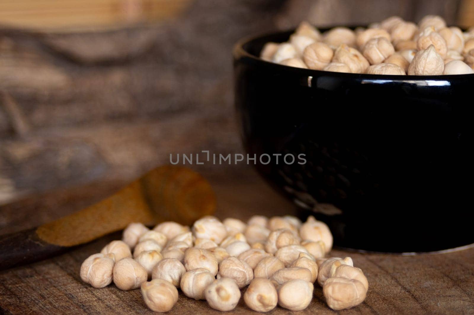 Chickpeas beans in black bowl . Still life.Blurred background.Still life by VeroDibe