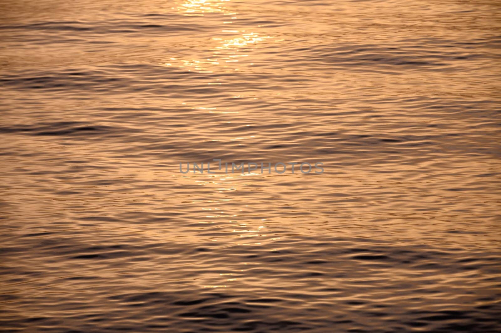 beautiful sunset of the Mediterranean sea, waves of golden color at sunset 1