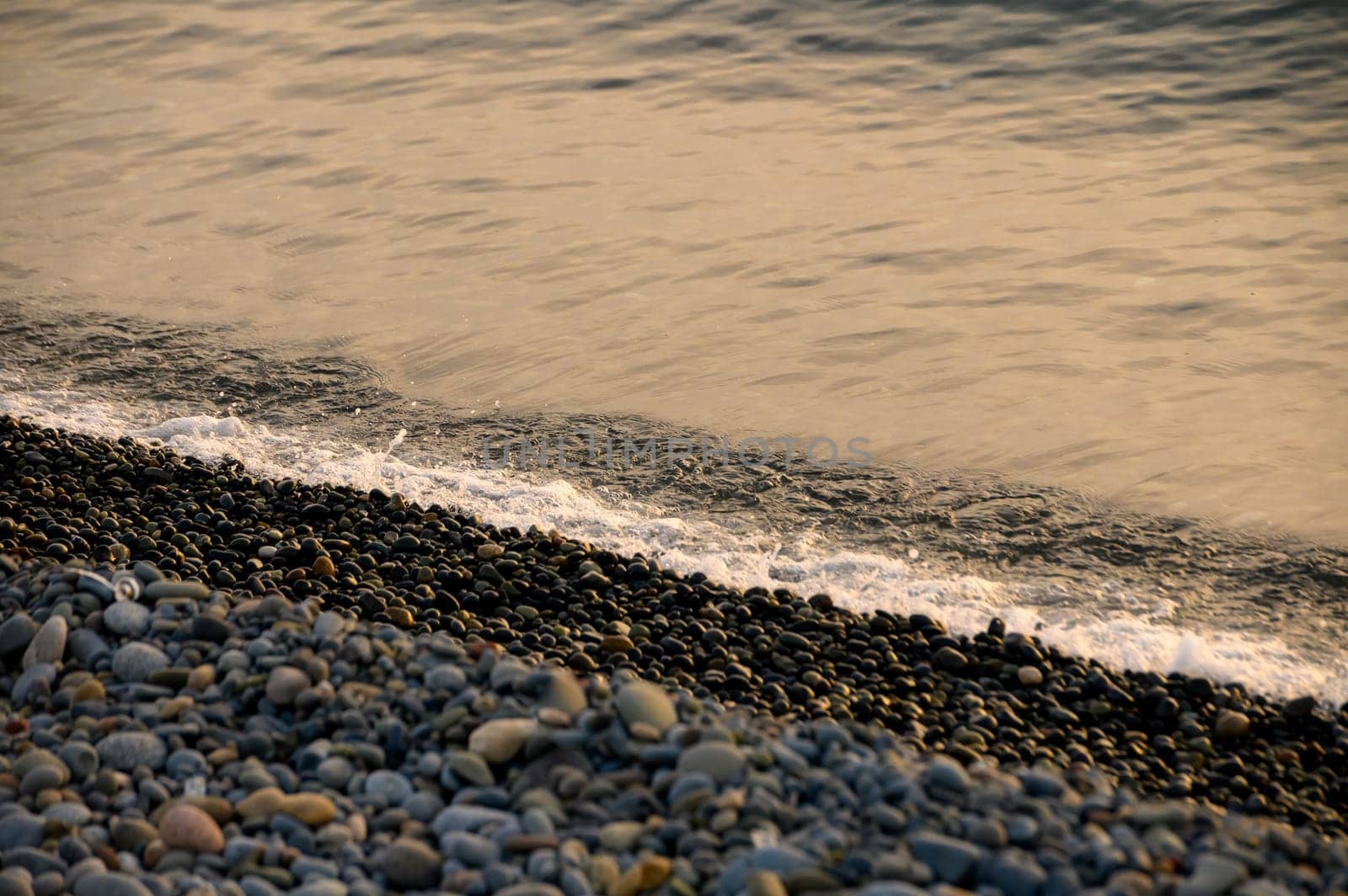 beautiful sunset of the Mediterranean sea, waves of golden color at sunset by Mixa74