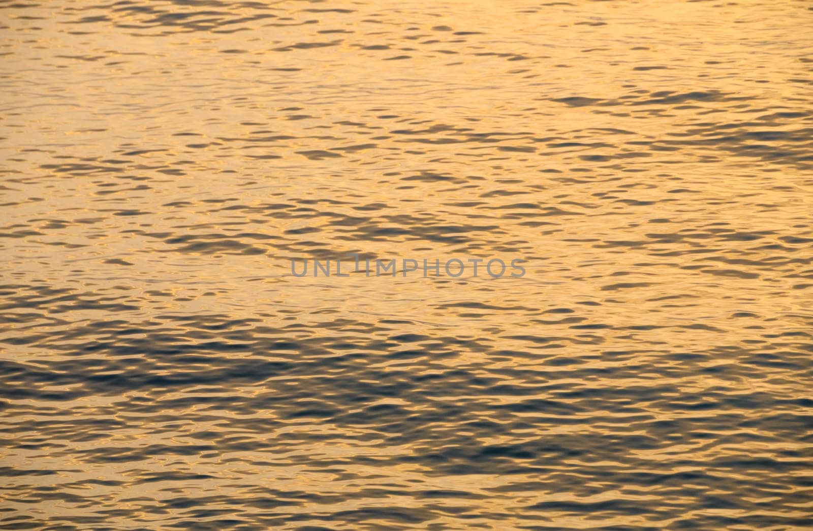 beautiful spring sunset of the Mediterranean sea golden waves at sunset